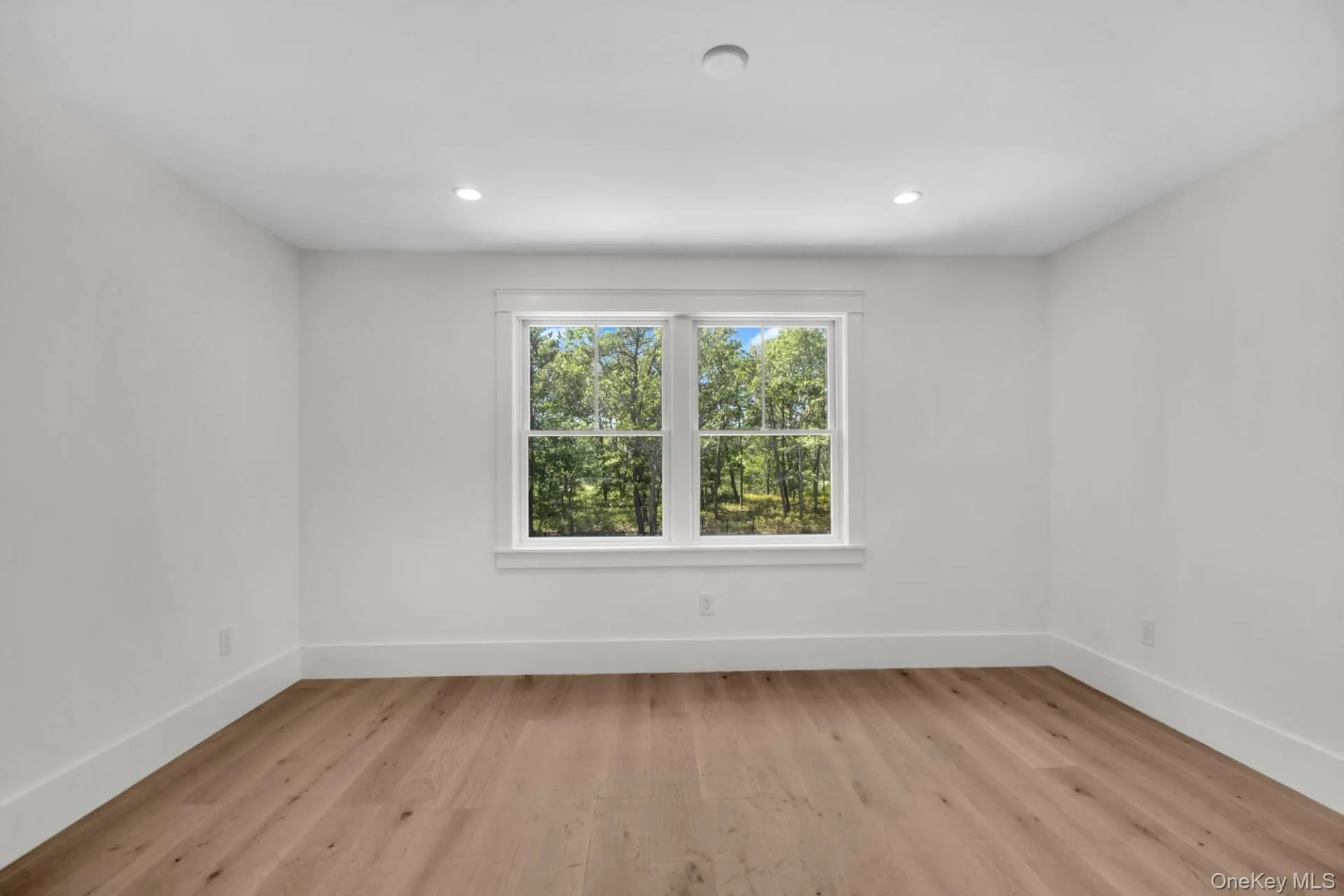Empty room with light wood-style flooring and recessed lighting Empty room with light wood-style flooring and recessed lighting