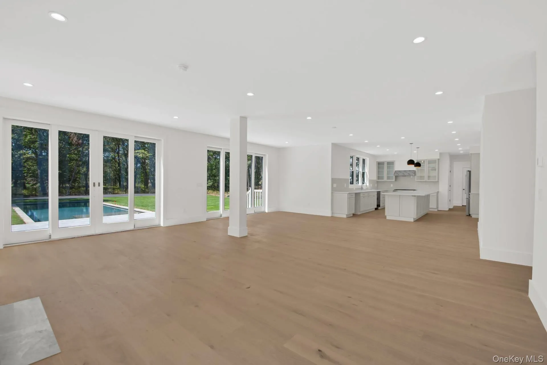 Unfurnished living room featuring recessed lighting and light wood-type flooring Unfurnished living room featuring recessed lighting and light wood-type flooring