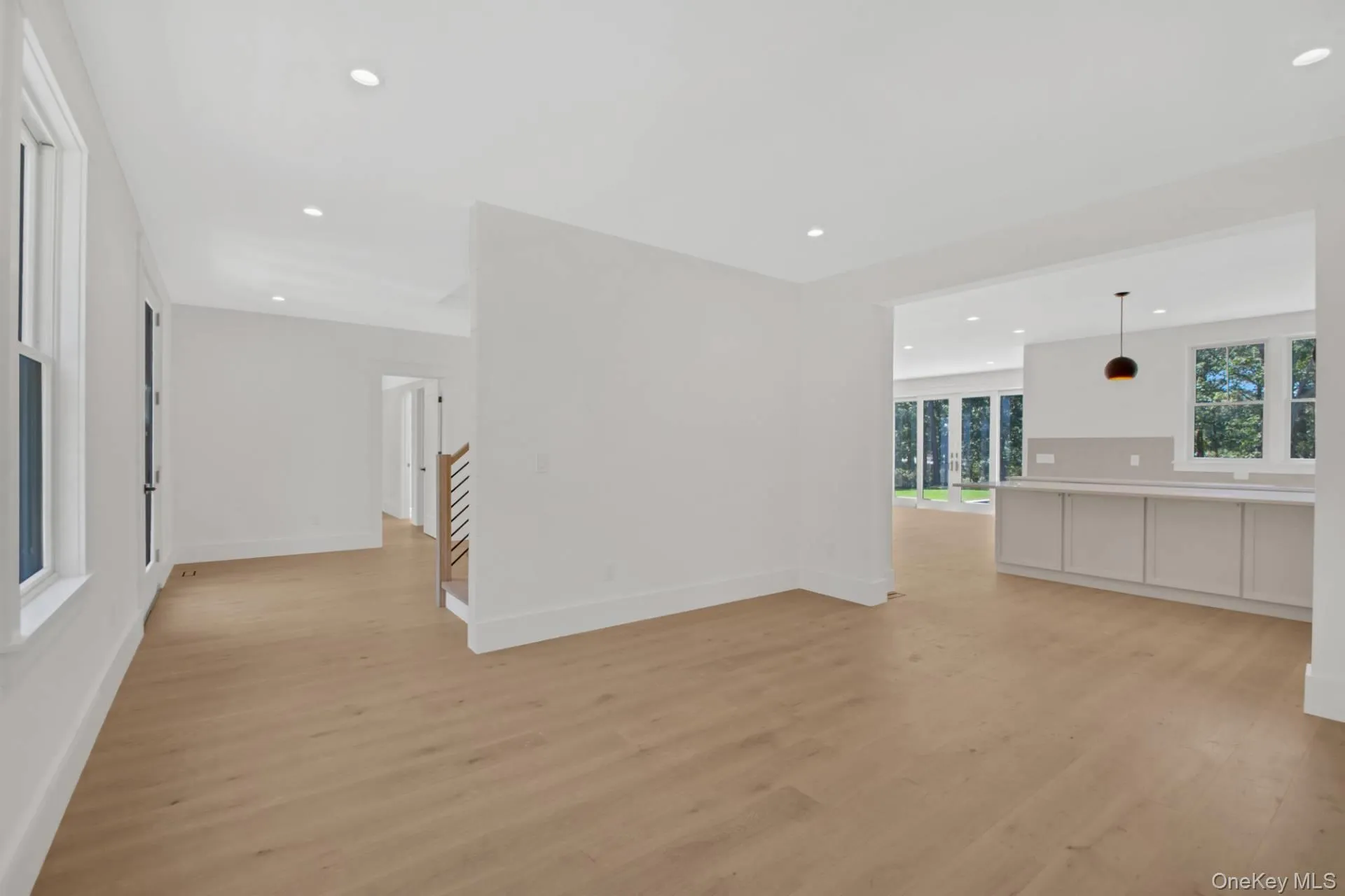 Unfurnished living room with light wood finished floors and recessed lighting Unfurnished living room with light wood finished floors and recessed lighting