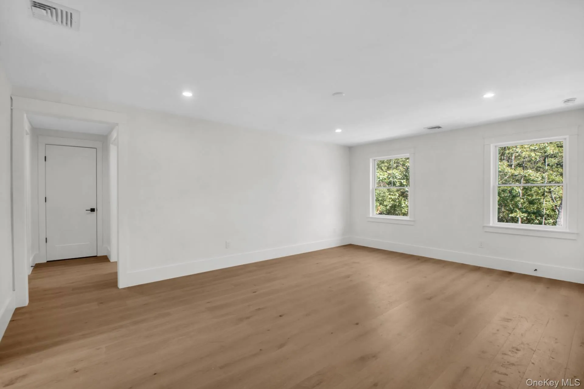Spare room with light wood-style flooring and recessed lighting Spare room with light wood-style flooring and recessed lighting