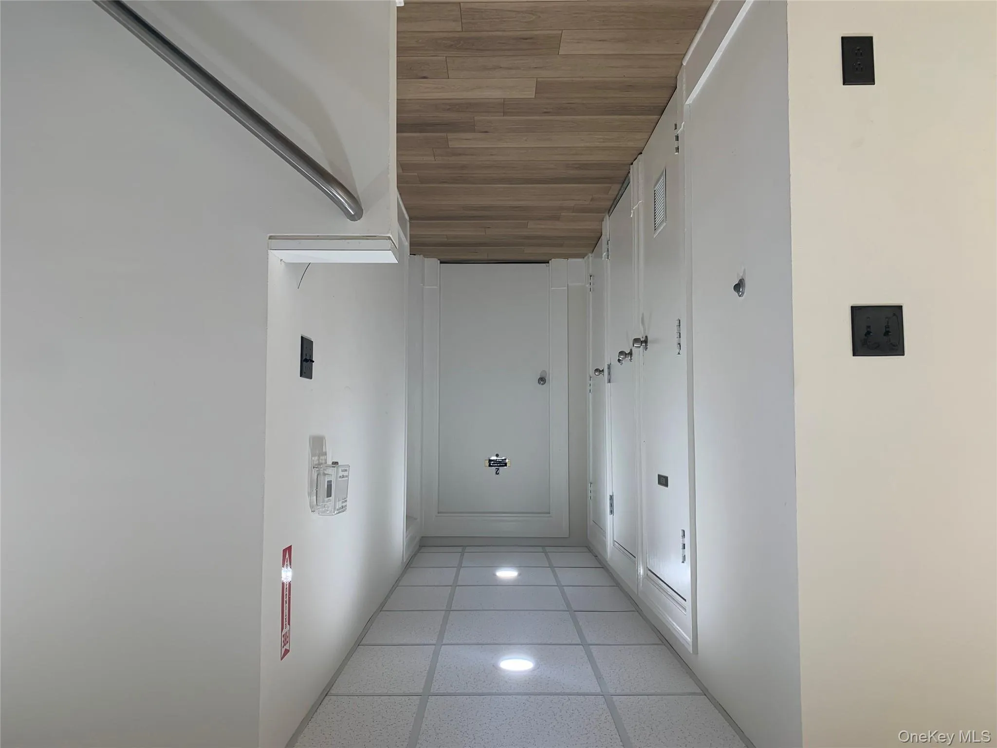 Hallway with a drop ceiling, wood finished floors, recessed lighting, and washer / dryer Hallway with a drop ceiling, wood finished floors, recessed lighting, and washer / dryer