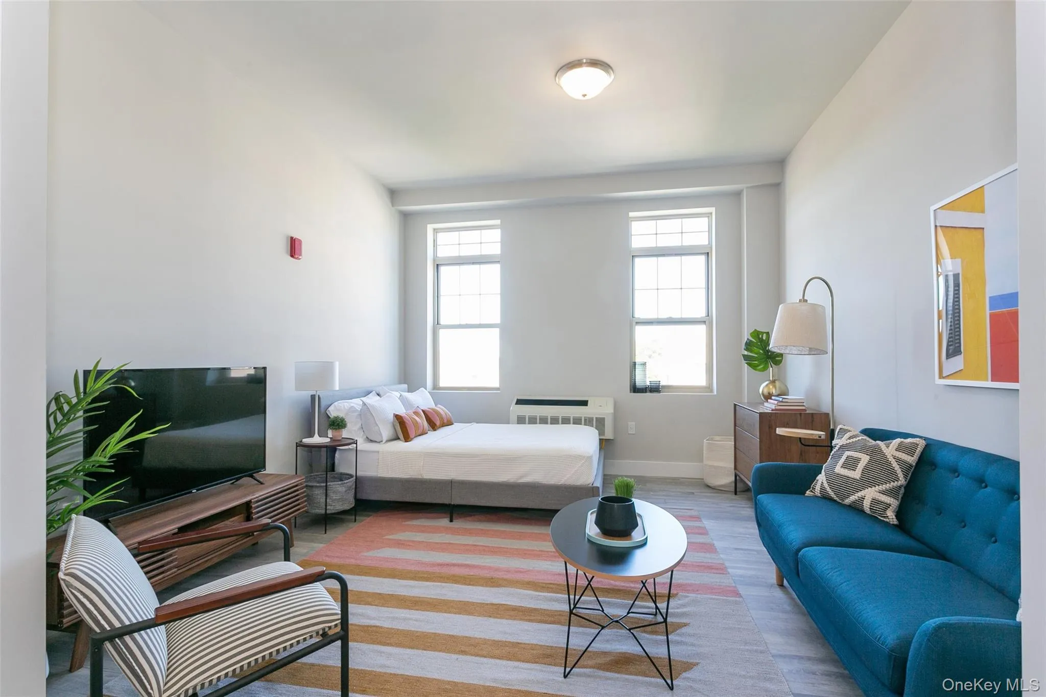 Bedroom with wood finished floors and a wall mounted AC Bedroom with wood finished floors and a wall mounted AC