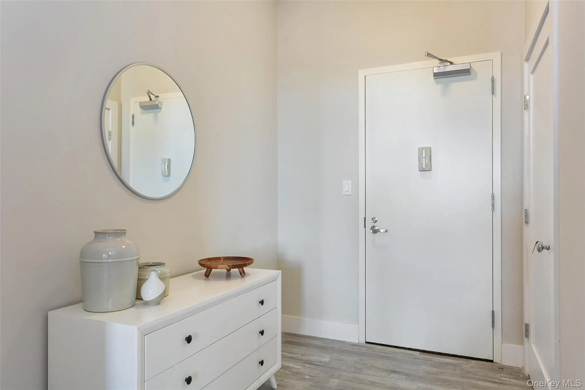 Entryway with wood finished floors and baseboards Entryway with wood finished floors and baseboards