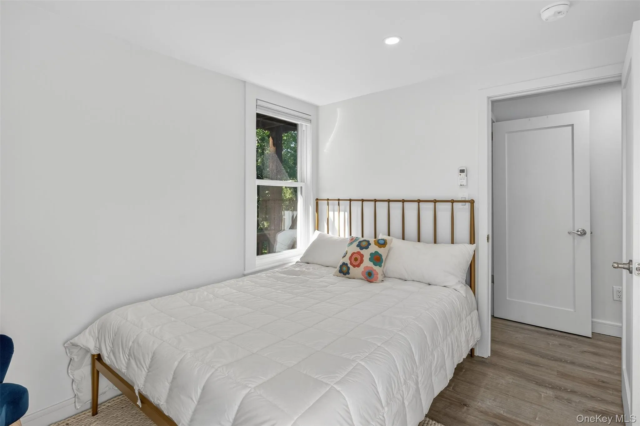 Bedroom with wood finished floors and recessed lighting Bedroom with wood finished floors and recessed lighting