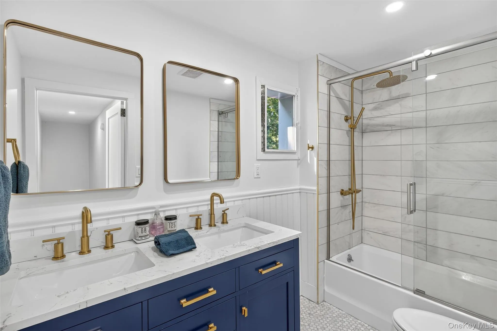 Full bath with combined bath / shower with glass door, double vanity, and recessed lighting Full bath with combined bath / shower with glass door, double vanity, and recessed lighting