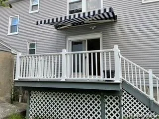 Back of property featuring a wooden deck Back of property featuring a wooden deck