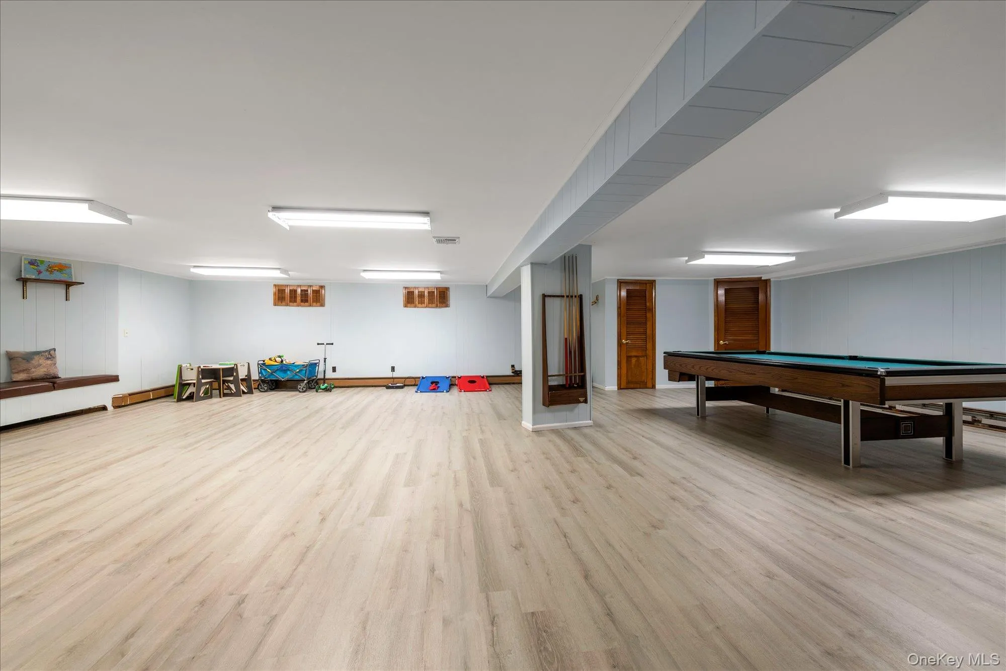Game room featuring light wood-style flooring, wooden walls, and billiards table Game room featuring light wood-style flooring, wooden walls, and billiards table