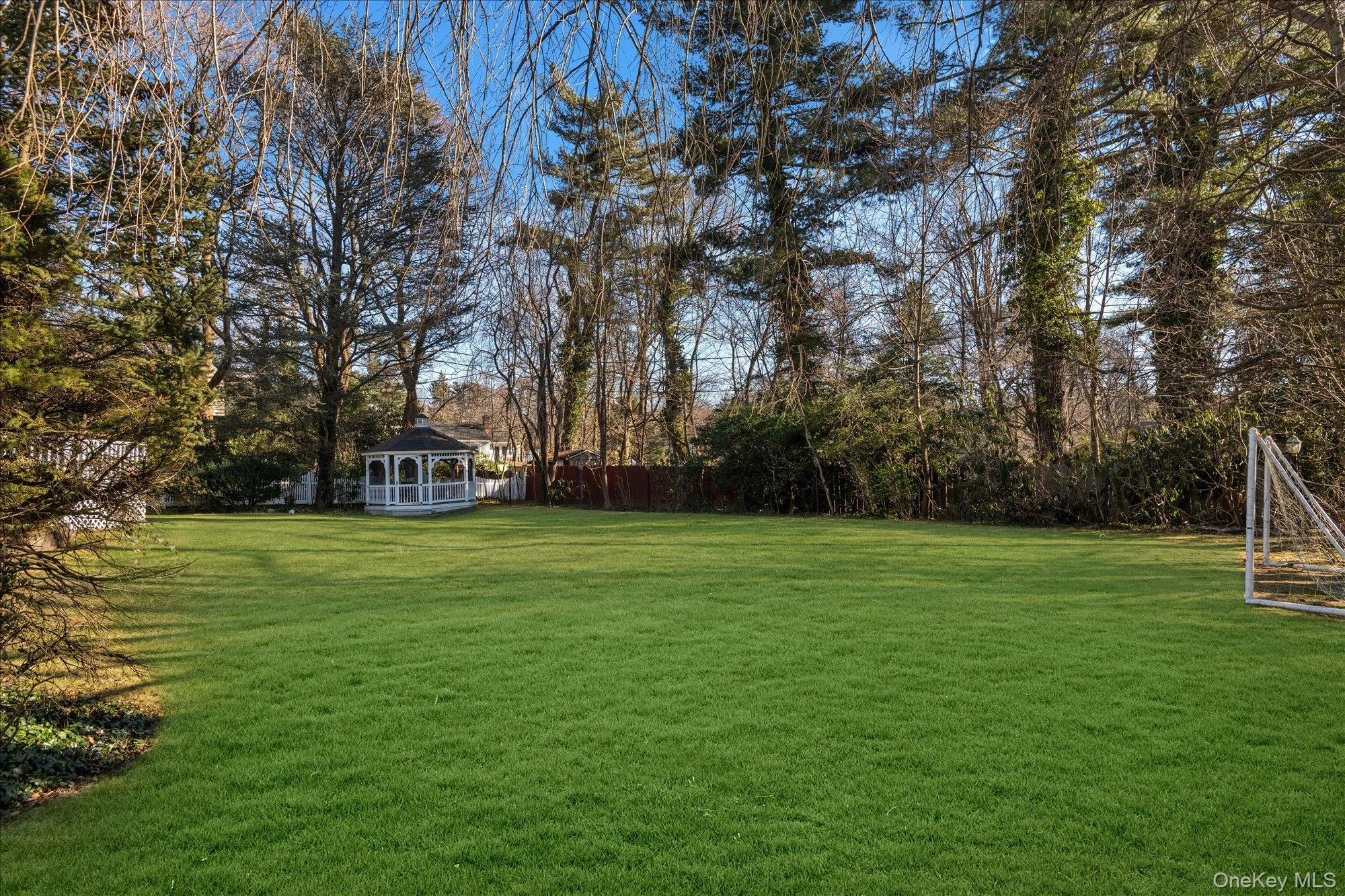 View of yard with a gazebo and view of wooded area View of yard with a gazebo and view of wooded area