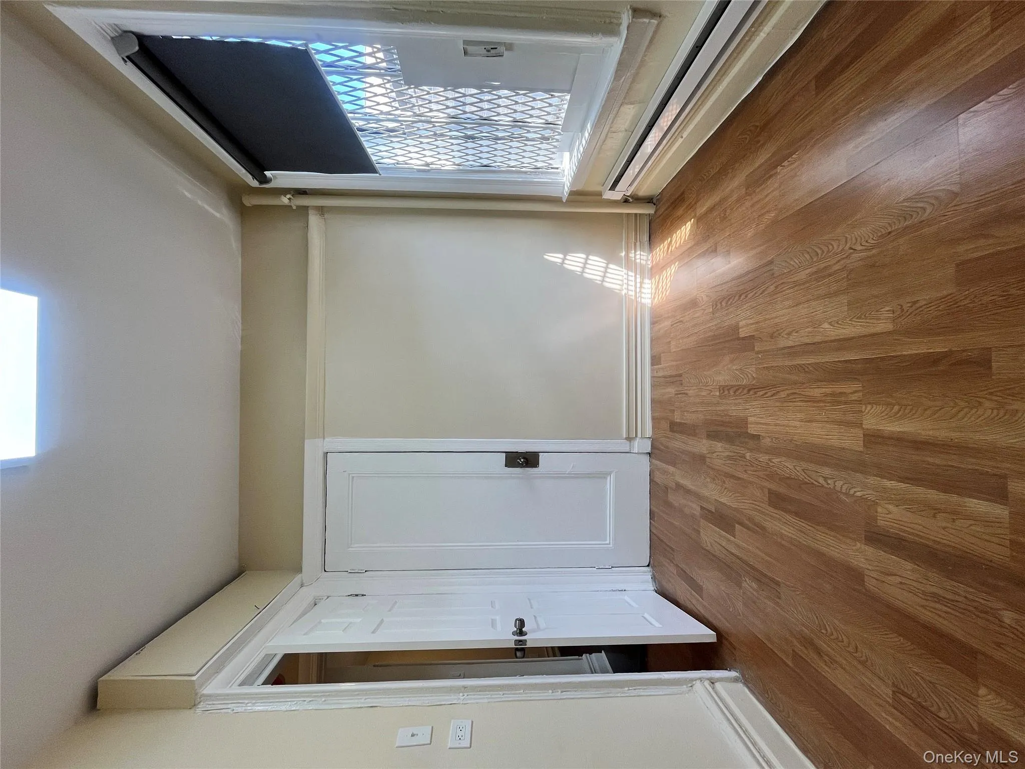 Unfurnished room featuring light wood-style flooring and a baseboard heating unit Unfurnished room featuring light wood-style flooring and a baseboard heating unit