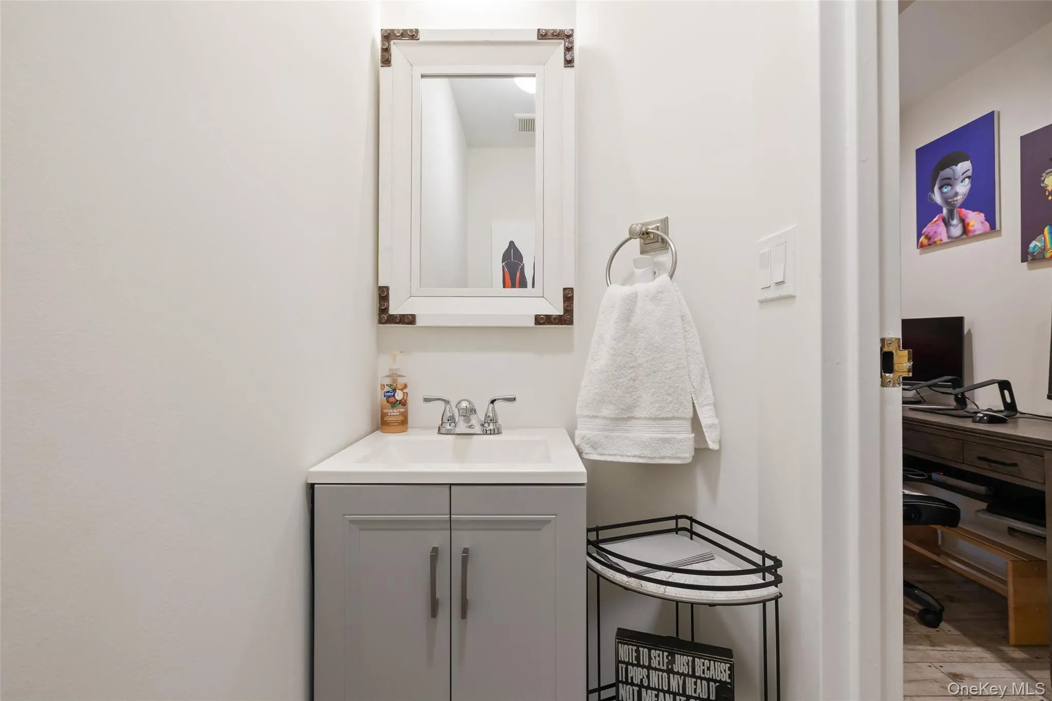 Bathroom with vanity and wood finished floors Bathroom with vanity and wood finished floors