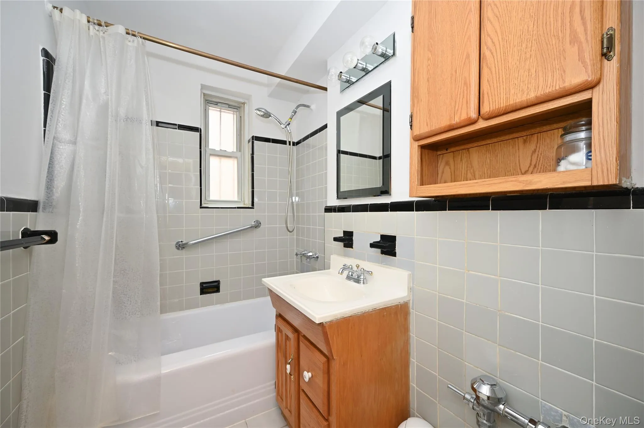 Full bath with shower / tub combo, tile walls, and vanity Full bath with shower / tub combo, tile walls, and vanity