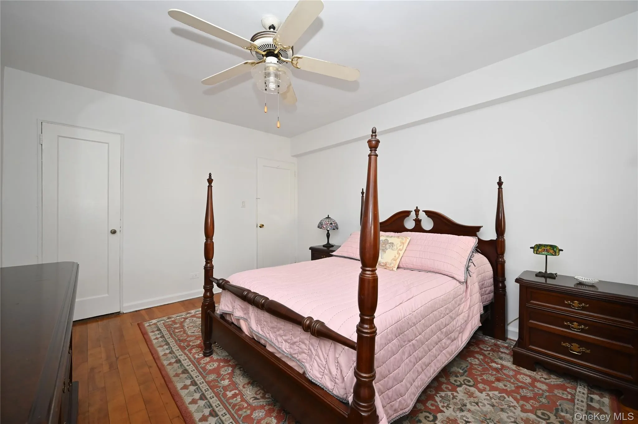 Bedroom featuring dark wood-style flooring and ceiling fan Bedroom featuring dark wood-style flooring and ceiling fan