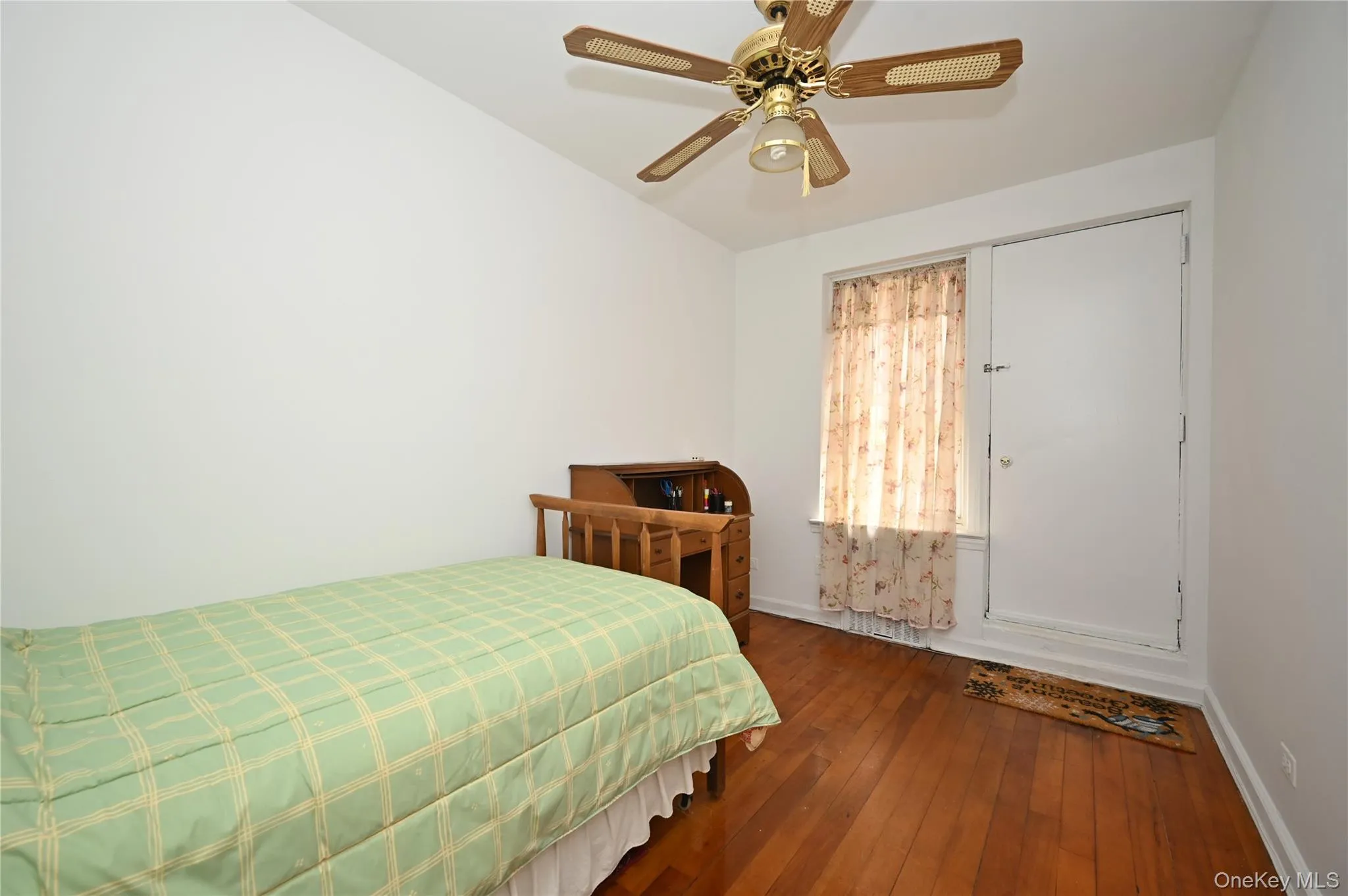 Bedroom featuring dark wood-style floors and ceiling fan Bedroom featuring dark wood-style floors and ceiling fan