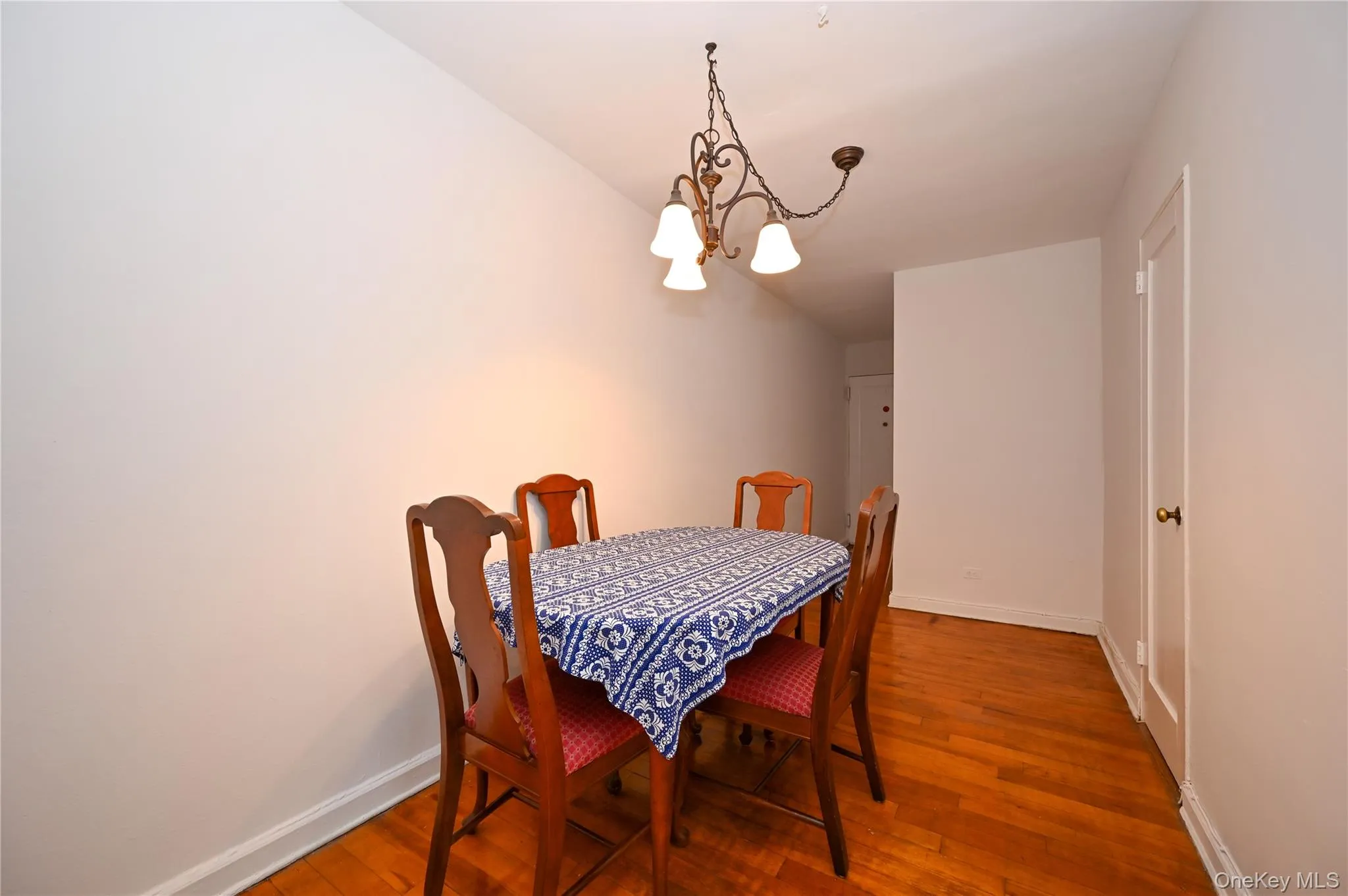 Dining space featuring hardwood / wood-style flooring and a chandelier Dining space featuring hardwood / wood-style flooring and a chandelier