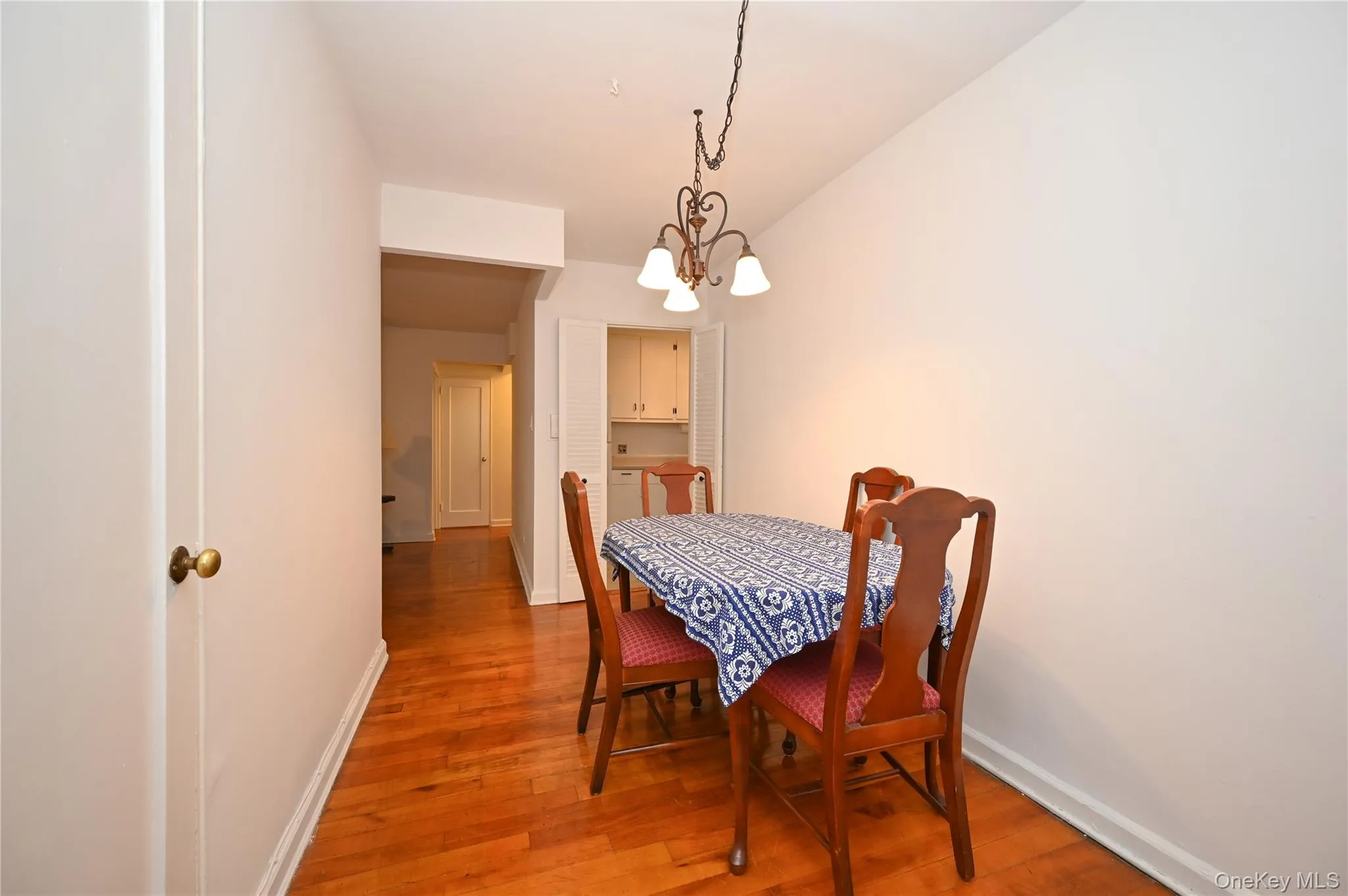 Dining area featuring light wood-style floors and a chandelier Dining area featuring light wood-style floors and a chandelier