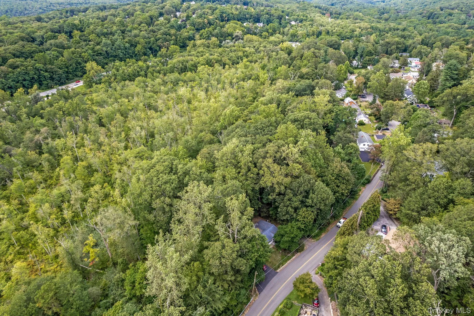 Aerial view of property's location featuring a heavily wooded area Aerial view of property's location featuring a heavily wooded area