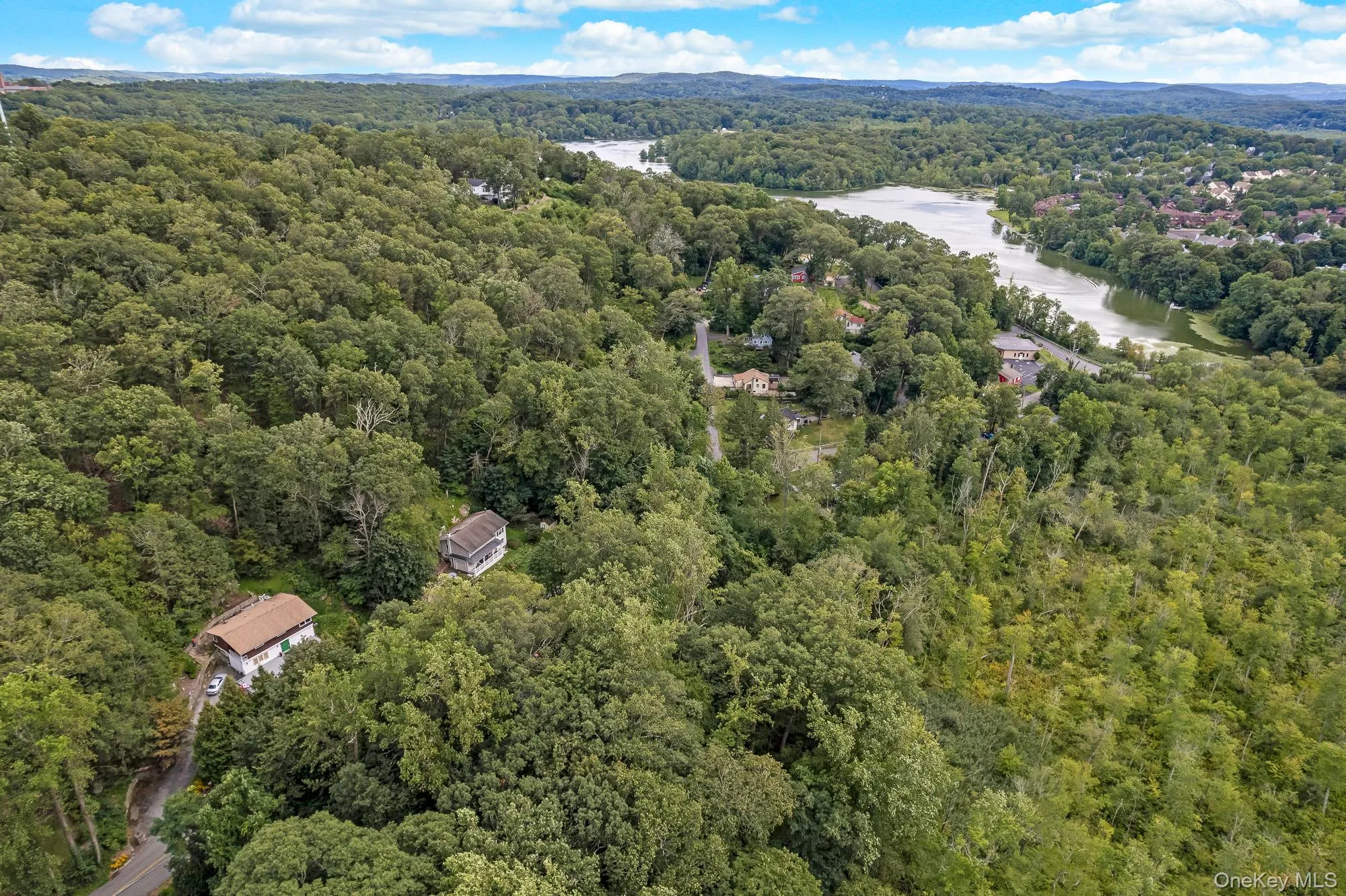 View of property location with a forest and a nearby body of water View of property location with a forest and a nearby body of water