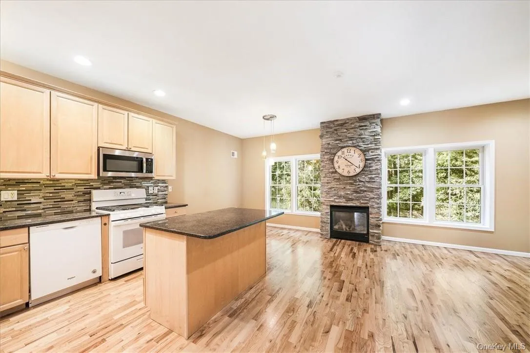 Large open kitchen with fireplace and even more entertaining space. Large open kitchen with fireplace and even more entertaining space.