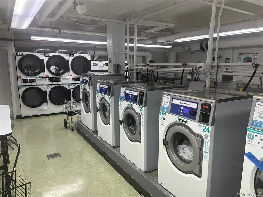 Shared laundry with light floors, stacked washer / dryer, and independent washer and dryer Shared laundry with light floors, stacked washer / dryer, and independent washer and dryer