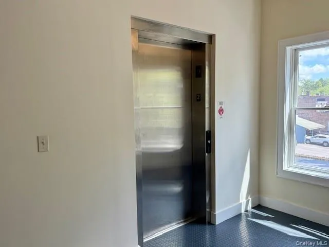 Doorway with elevator and baseboards Doorway with elevator and baseboards