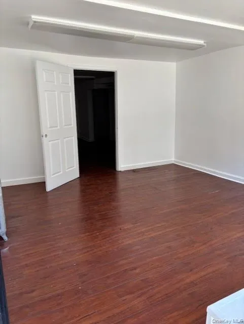 Unfurnished room with dark wood-style floors Unfurnished room with dark wood-style floors