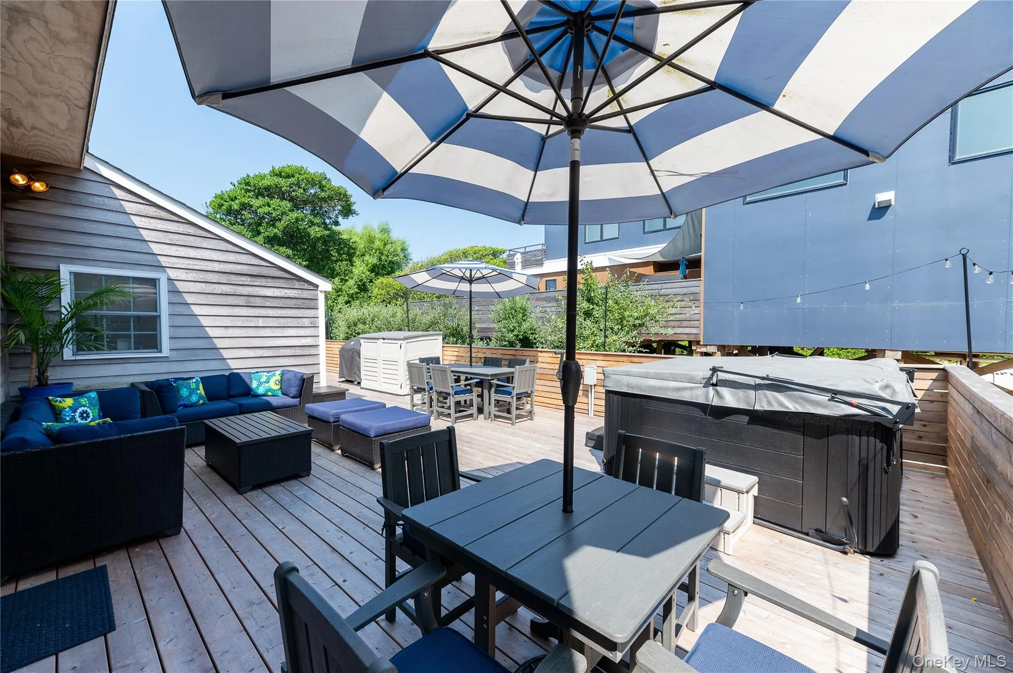 Deck with outdoor dining space, a hot tub, and outdoor lounge area Deck with outdoor dining space, a hot tub, and outdoor lounge area