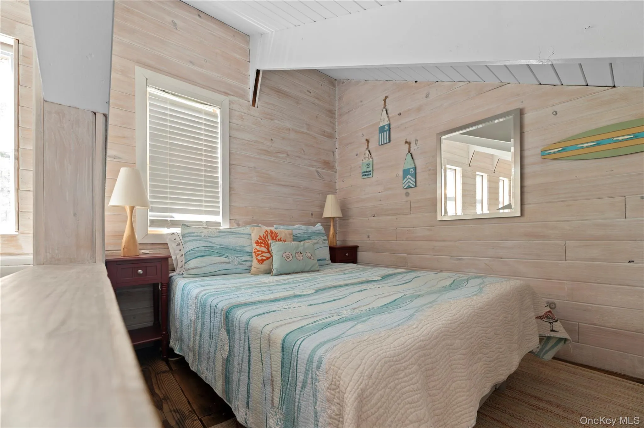 Bedroom featuring wood walls, wood finished floors, and a wooden ceiling with exposed beams Bedroom featuring wood walls, wood finished floors, and a wooden ceiling with exposed beams