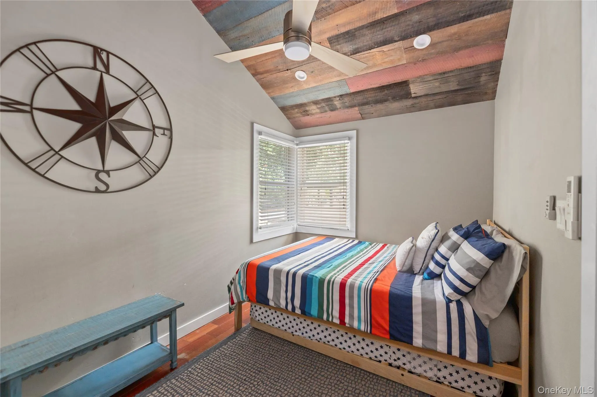 Bedroom featuring dark wood-style floors, wooden ceiling, and ceiling fan Bedroom featuring dark wood-style floors, wooden ceiling, and ceiling fan