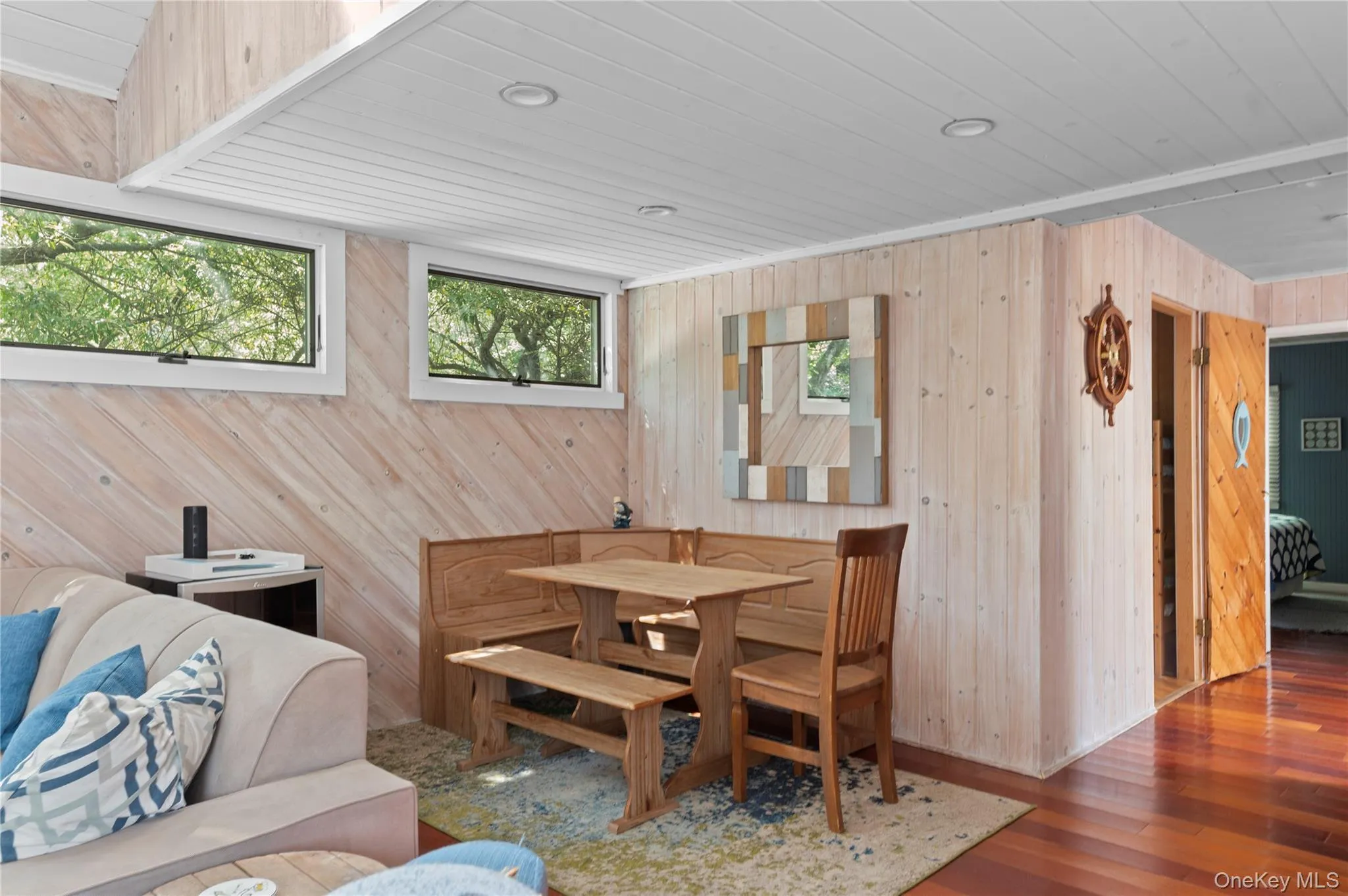 Dining area featuring wood walls and hardwood / wood-style flooring Dining area featuring wood walls and hardwood / wood-style flooring