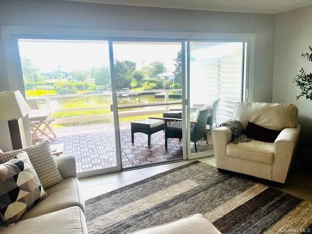 Tiled living area with a water view Tiled living area with a water view