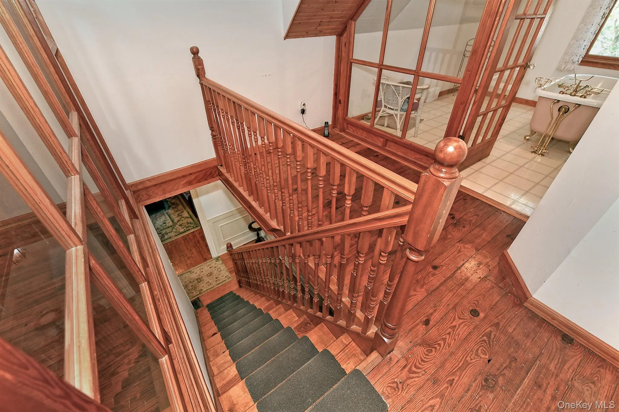 Staircase featuring wood finished floors Staircase featuring wood finished floors