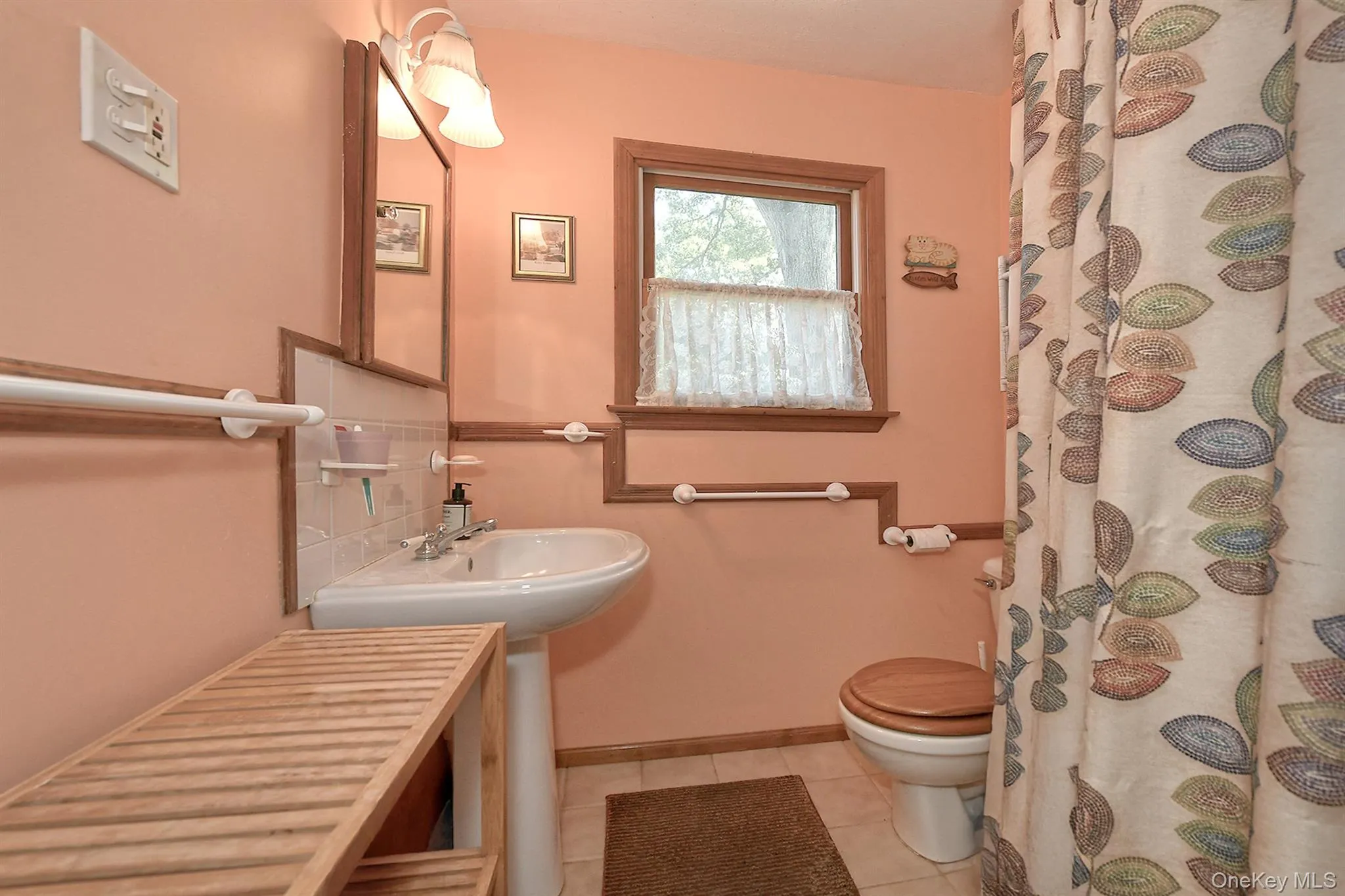 Bathroom with light tile patterned flooring and curtained shower Bathroom with light tile patterned flooring and curtained shower