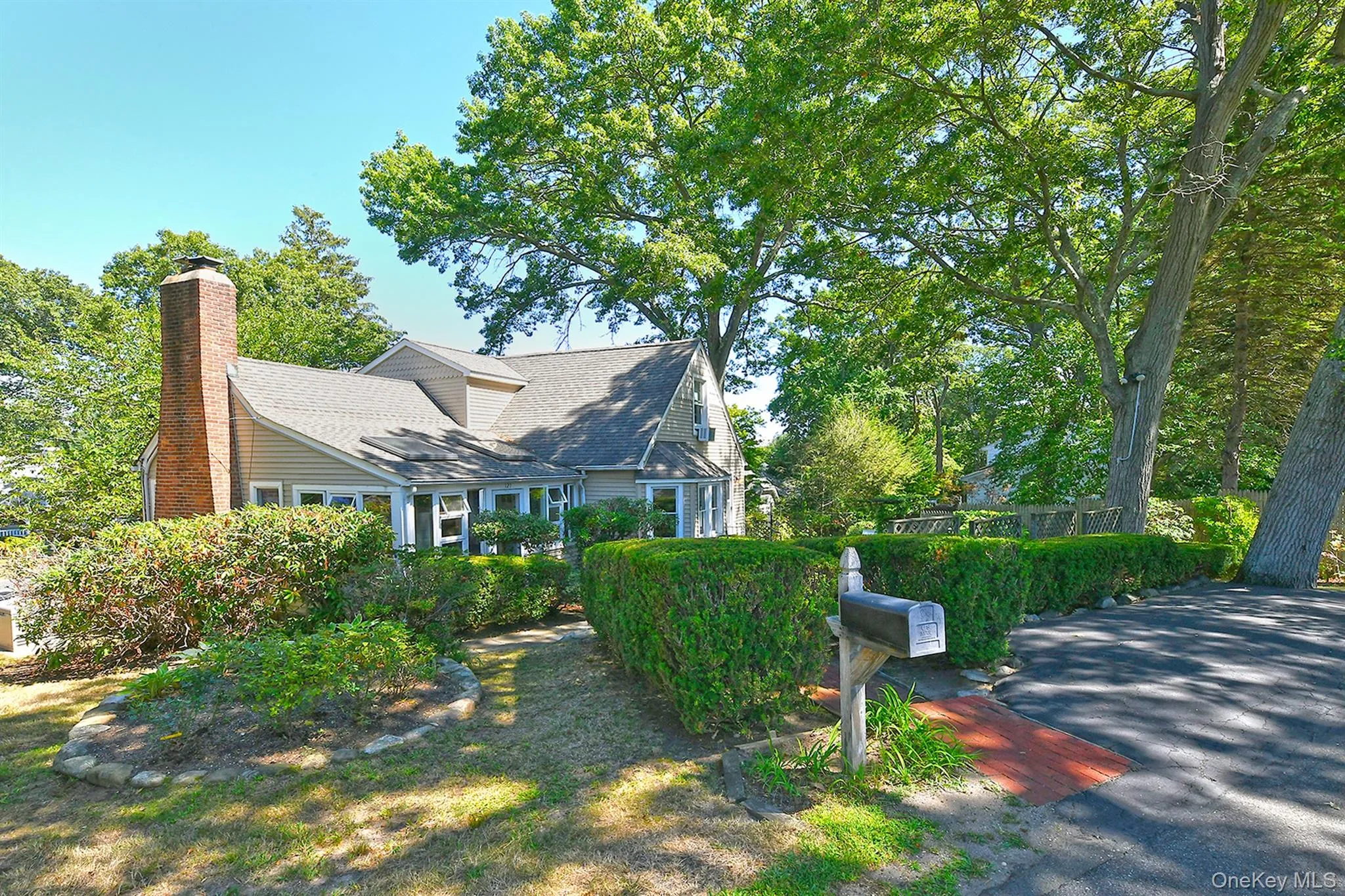 View of side of property with a chimney and roof with shingles View of side of property with a chimney and roof with shingles