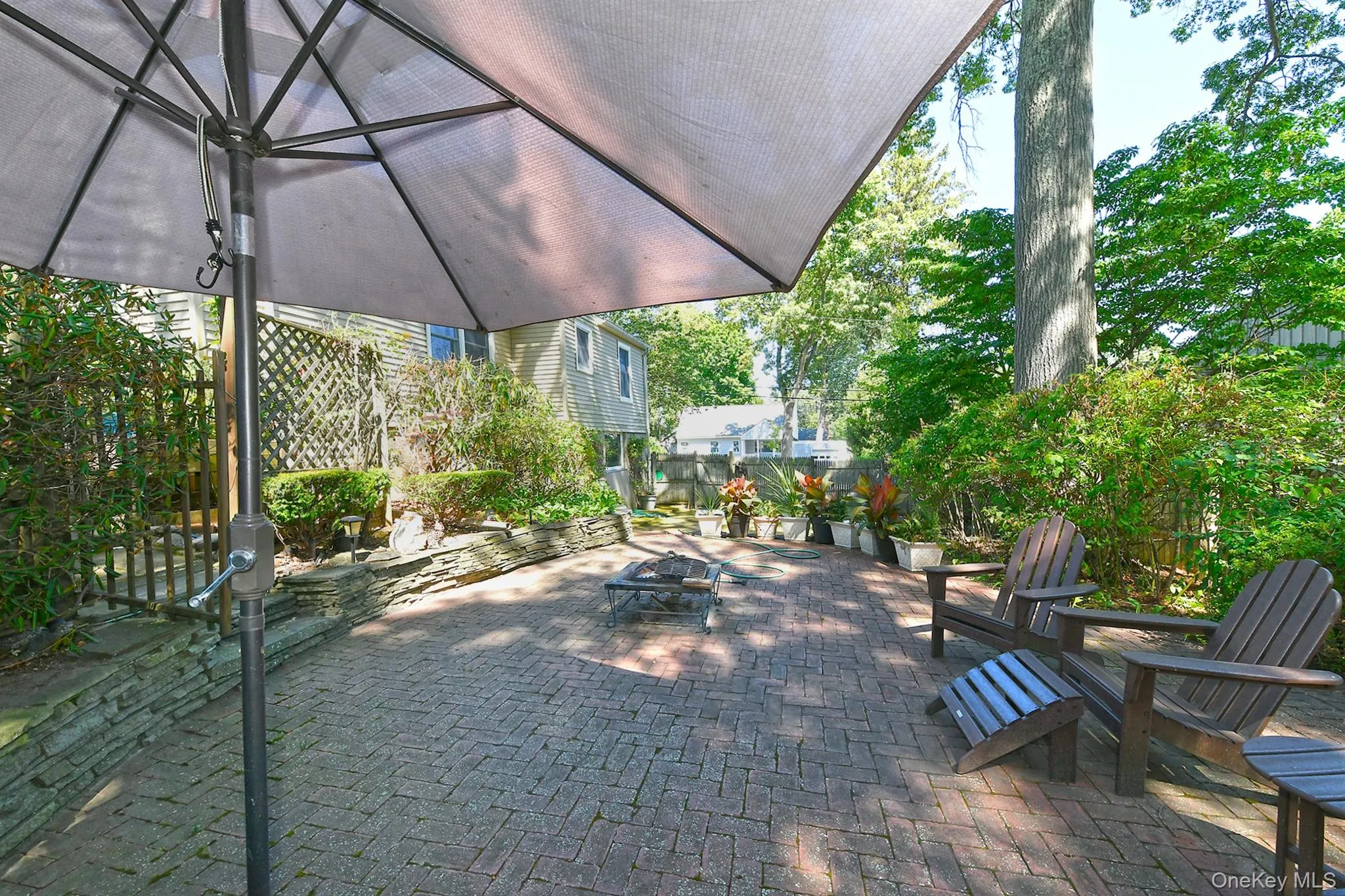 View of patio / terrace with an outdoor fire pit View of patio / terrace with an outdoor fire pit