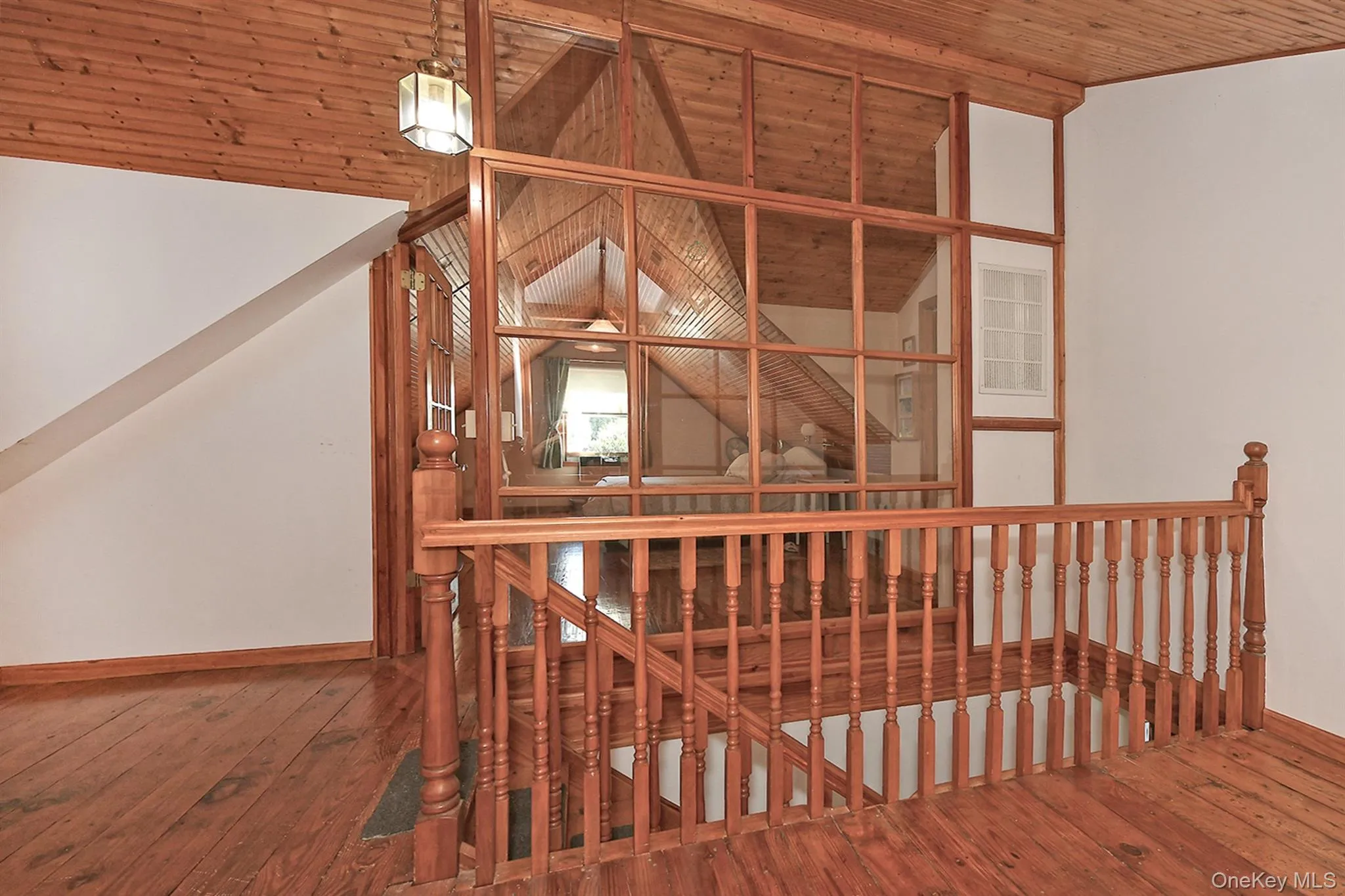 Stairs with wood-type flooring, vaulted ceiling, and wooden ceiling Stairs with wood-type flooring, vaulted ceiling, and wooden ceiling
