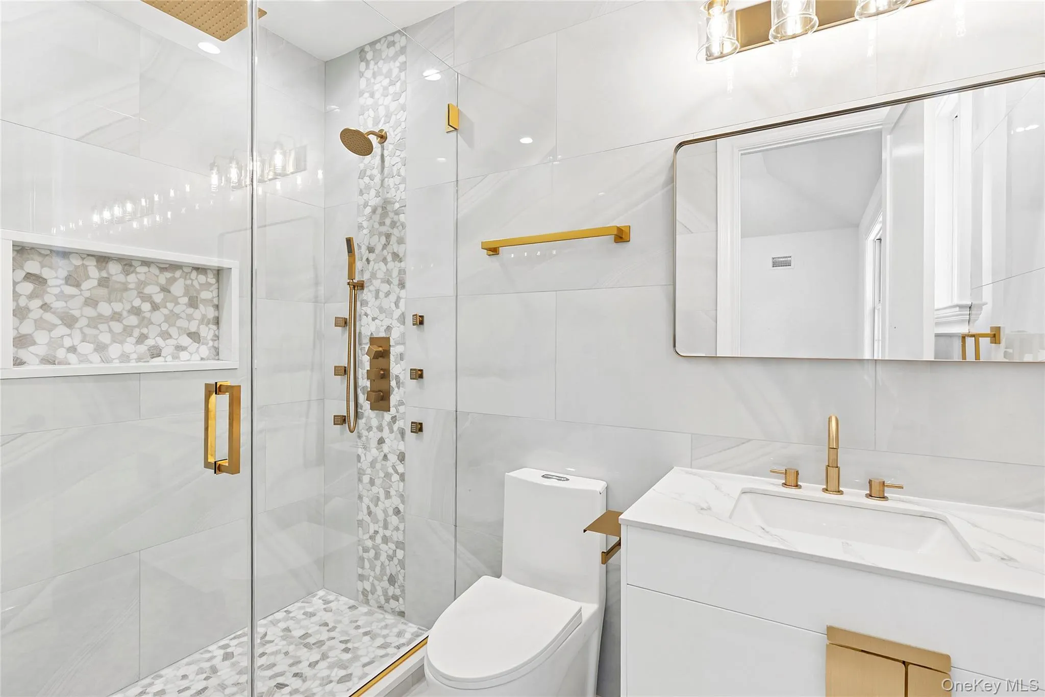 Bathroom with vanity, a stall shower, and tile walls Bathroom with vanity, a stall shower, and tile walls