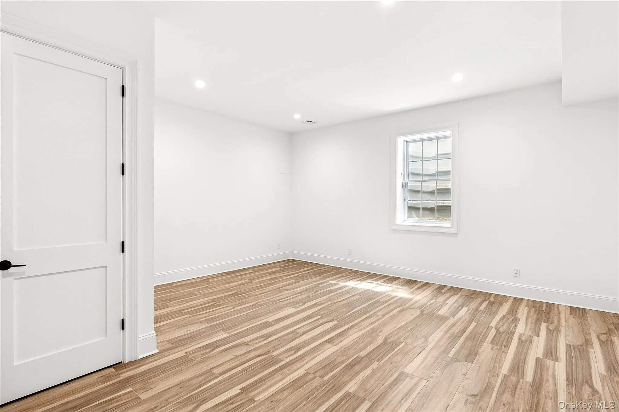 Spare room featuring recessed lighting and light wood-style flooring Spare room featuring recessed lighting and light wood-style flooring