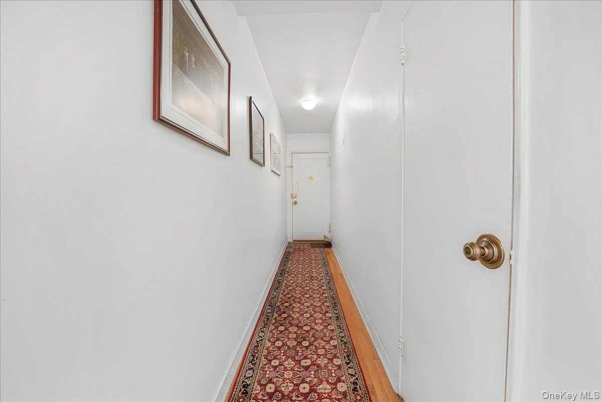Corridor with baseboards and wood finished floors Corridor with baseboards and wood finished floors