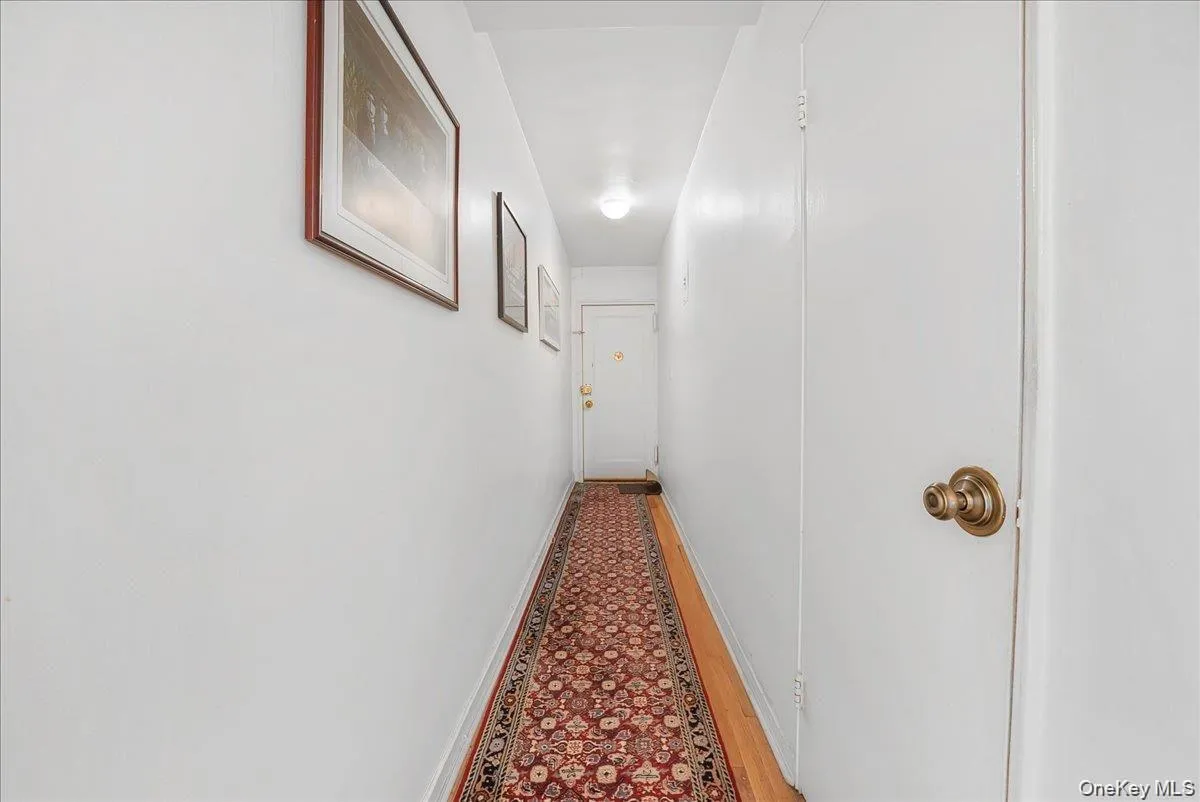Corridor with baseboards and wood finished floors Corridor with baseboards and wood finished floors