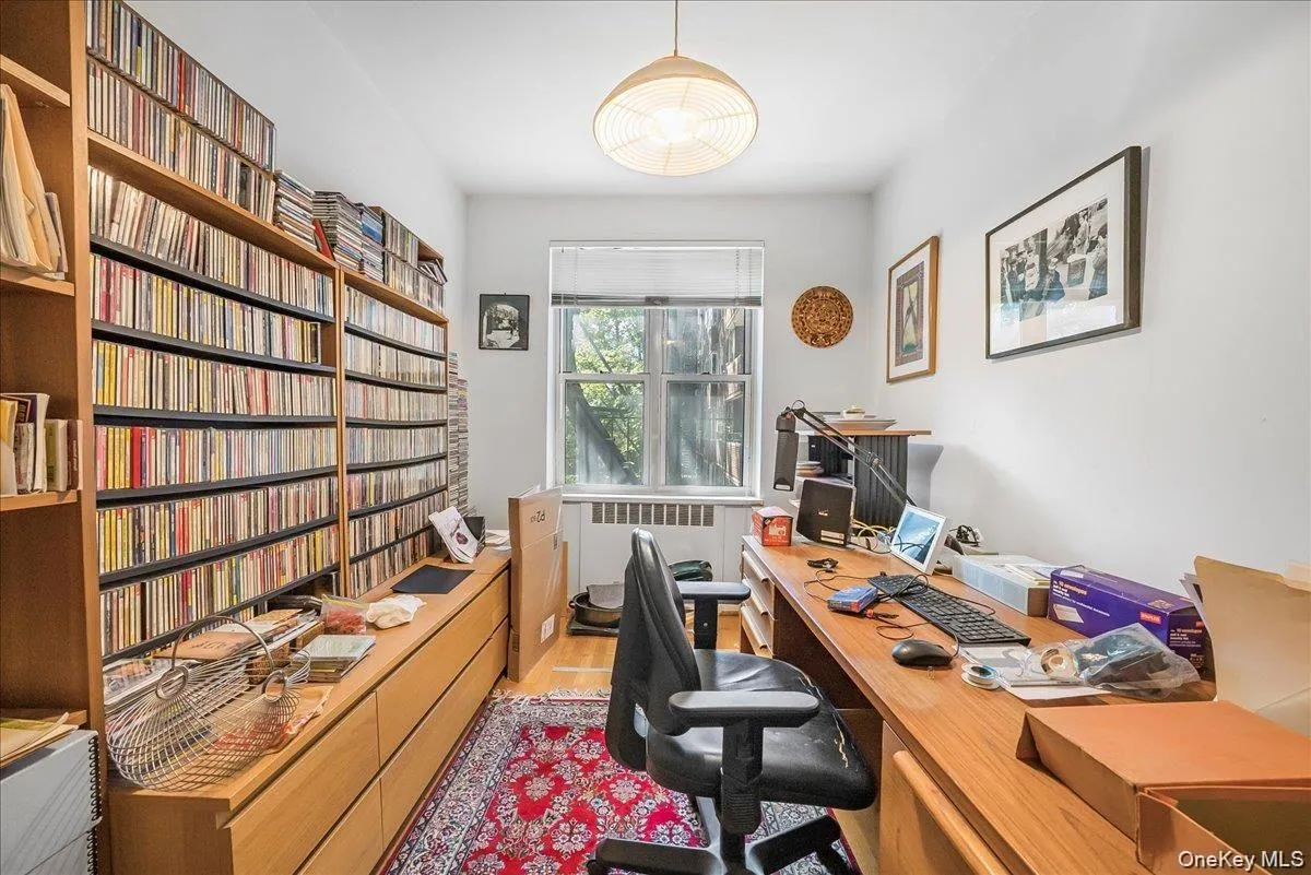 Home office with radiator heating unit and light wood finished floors Home office with radiator heating unit and light wood finished floors