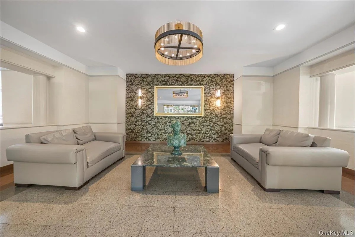 Building lobby featuring wallpapered walls and recessed lighting Building lobby featuring wallpapered walls and recessed lighting