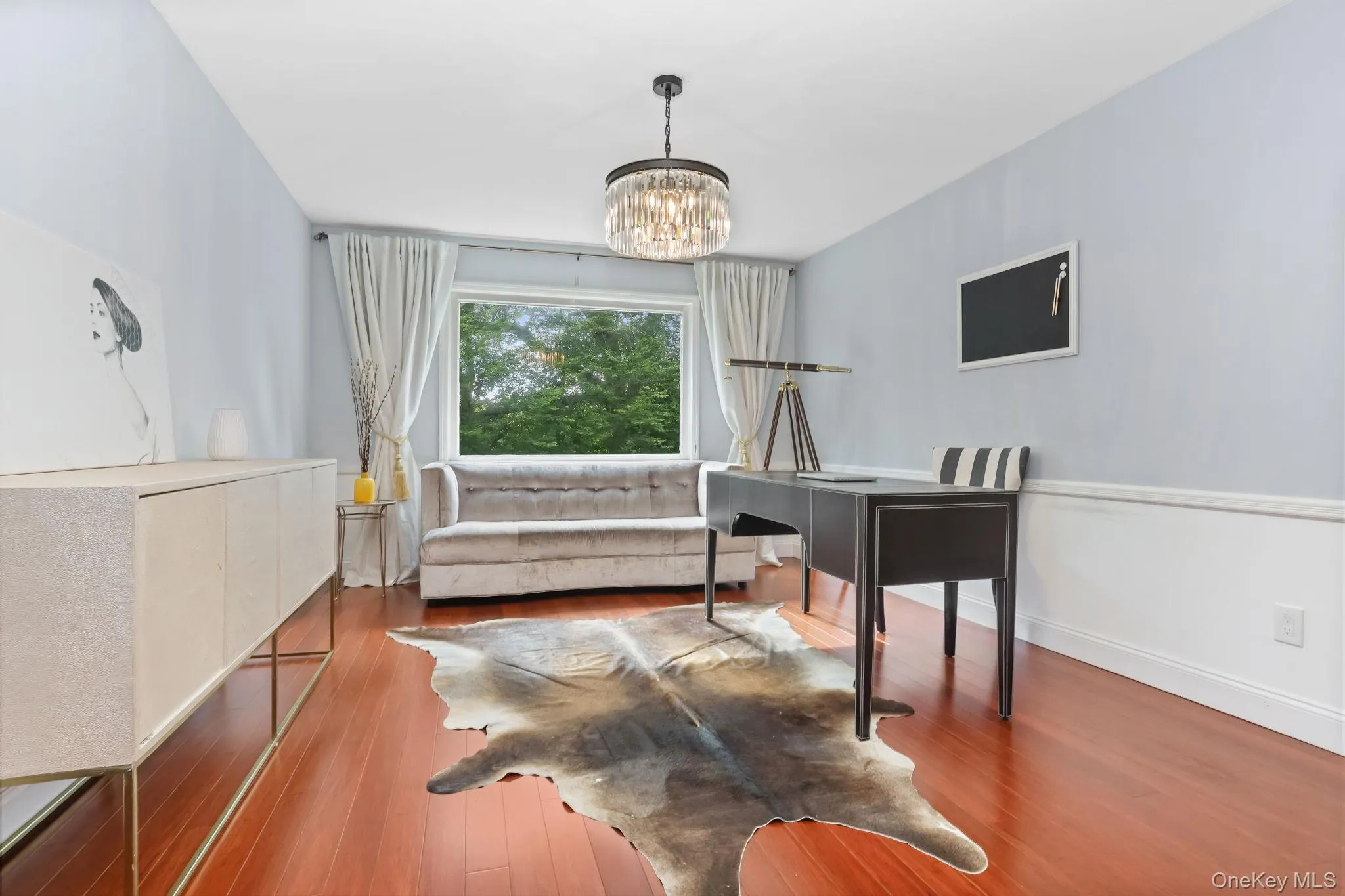 Home office with wood finished floors and a chandelier Home office with wood finished floors and a chandelier