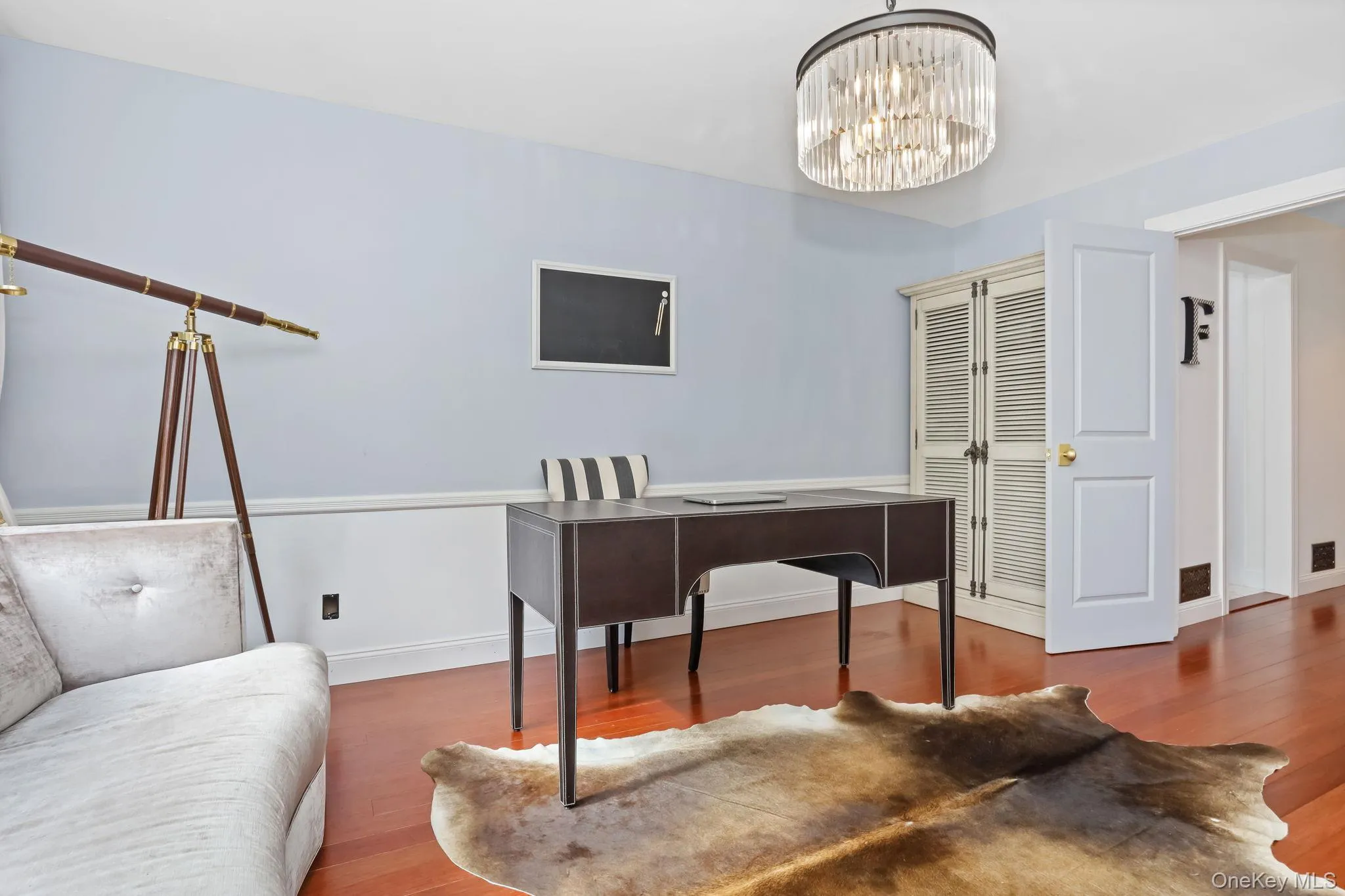 Office with wood finished floors and a chandelier Office with wood finished floors and a chandelier