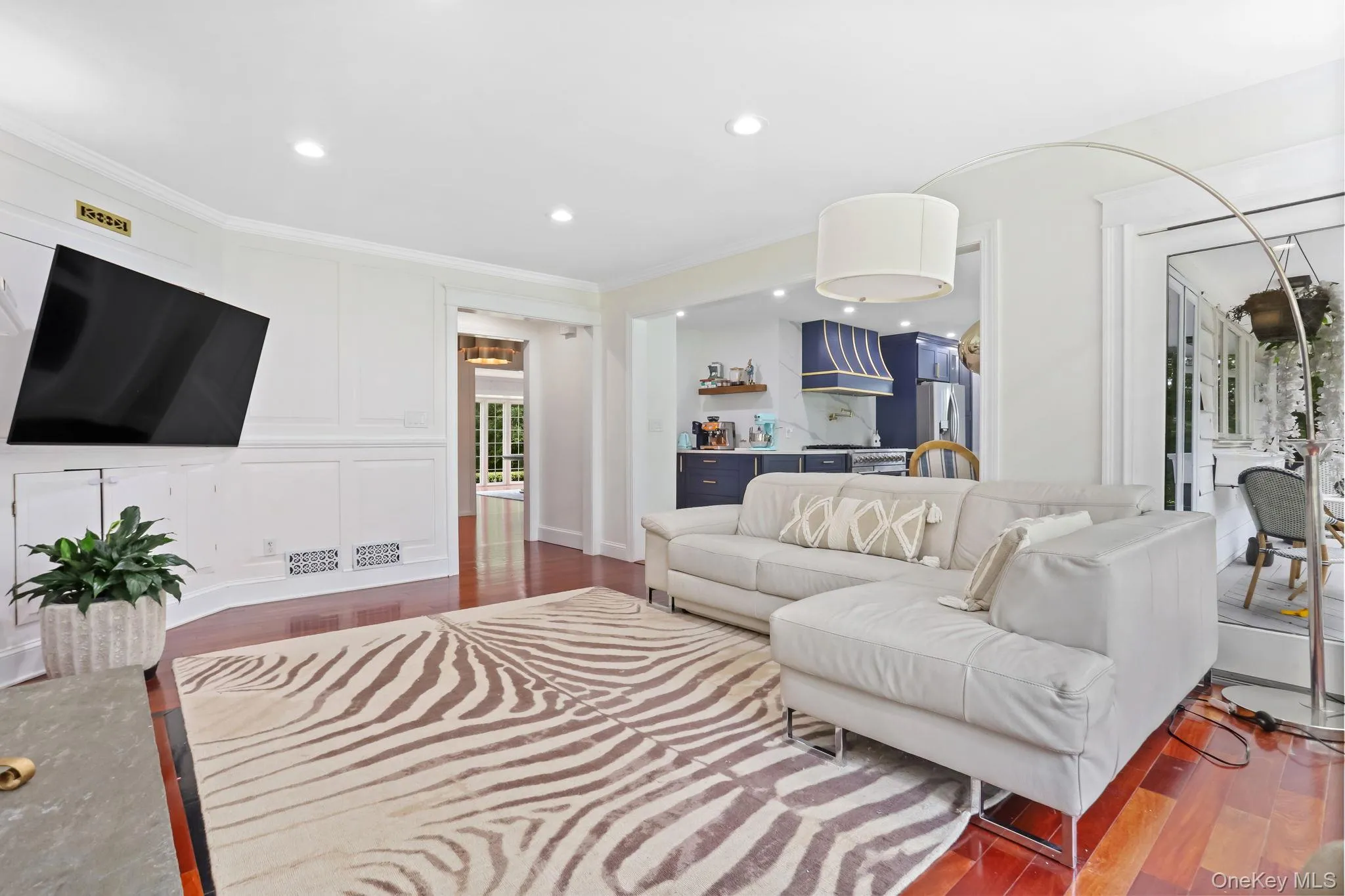Living area featuring dark wood finished floors, recessed lighting, and crown molding Living area featuring dark wood finished floors, recessed lighting, and crown molding