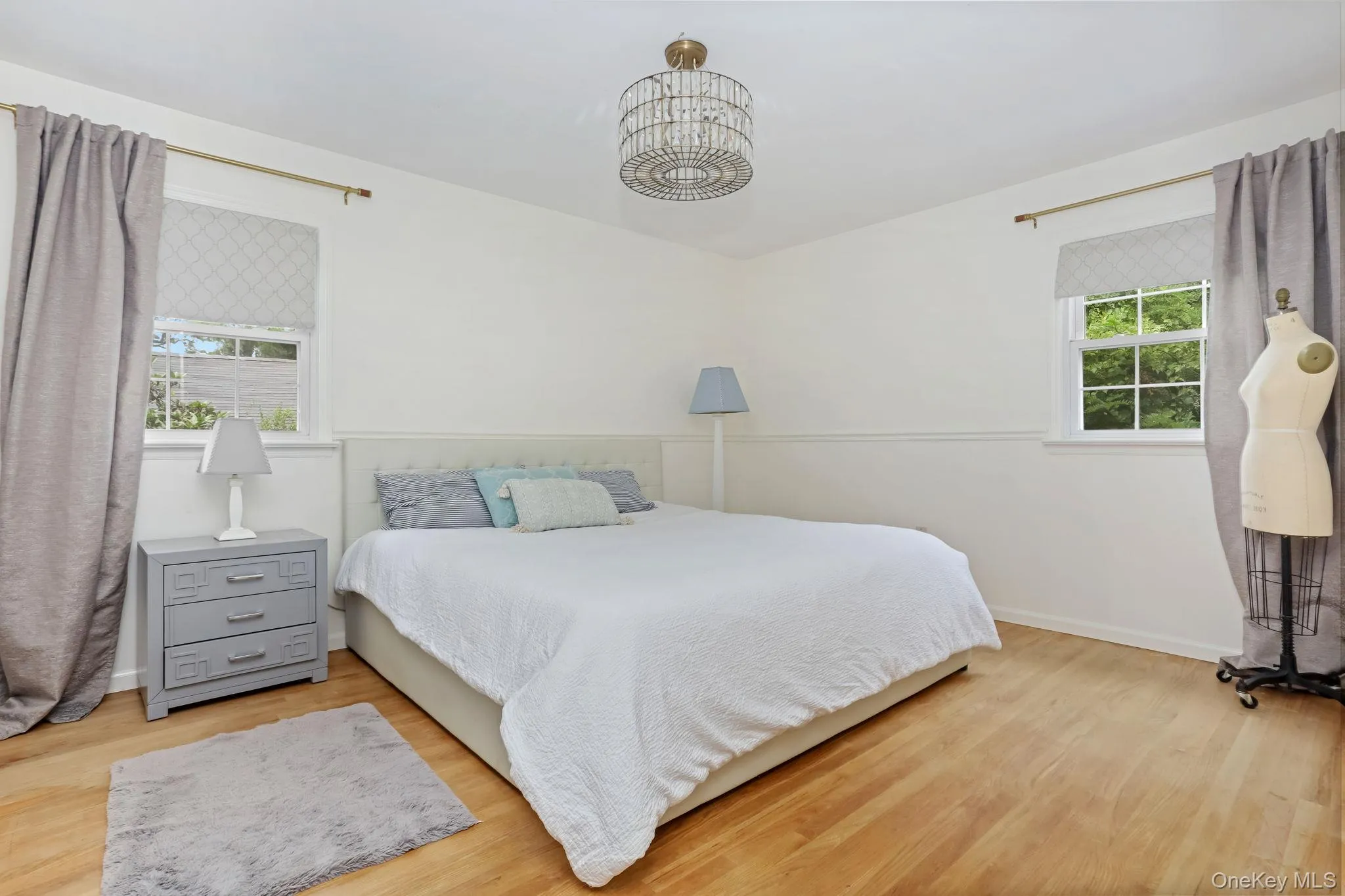Bedroom with wood finished floors and a chandelier Bedroom with wood finished floors and a chandelier