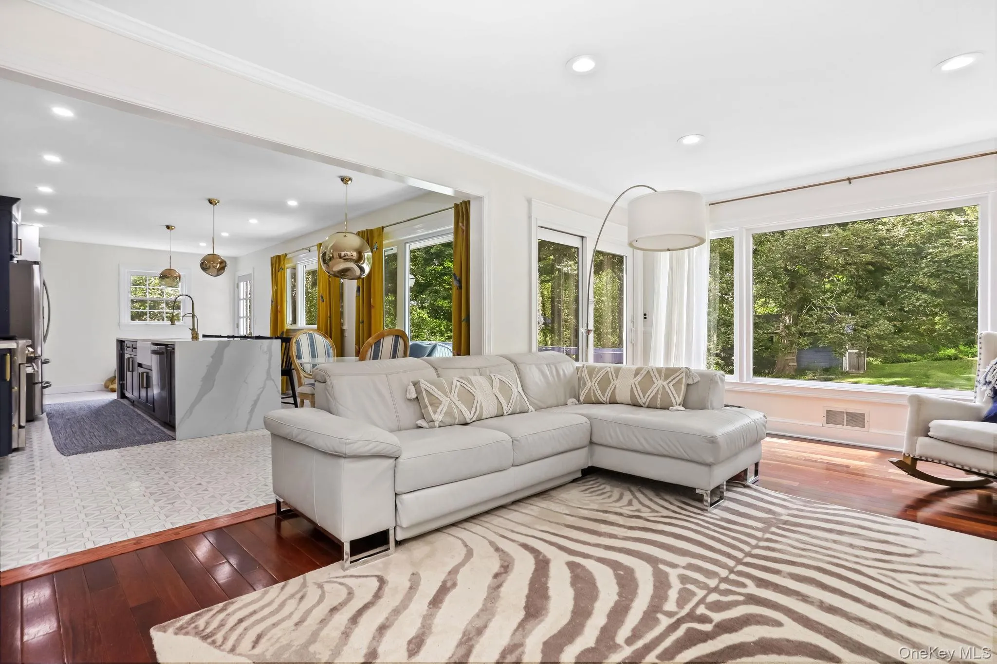Living area with dark wood-style floors and recessed lighting Living area with dark wood-style floors and recessed lighting