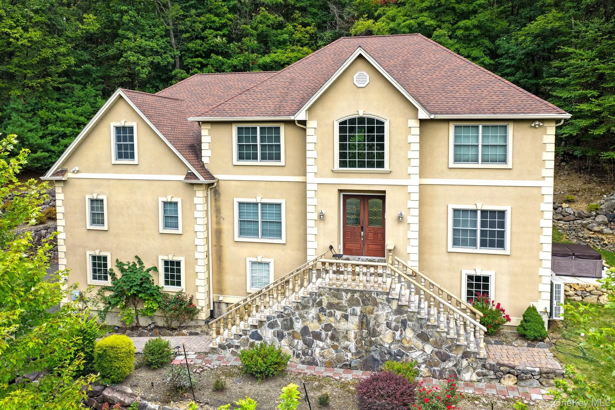 View of front of home featuring stucco siding, stairs, and a shingled roof View of front of home featuring stucco siding, stairs, and a shingled roof