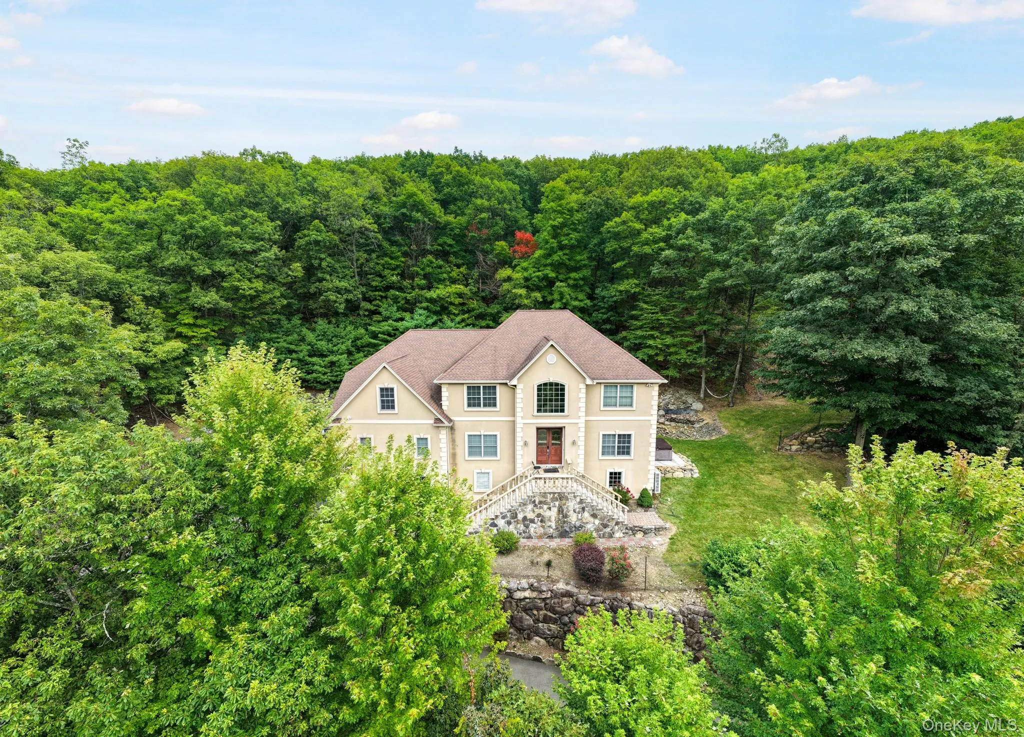 Aerial view of property and surrounding area featuring a heavily wooded area Aerial view of property and surrounding area featuring a heavily wooded area