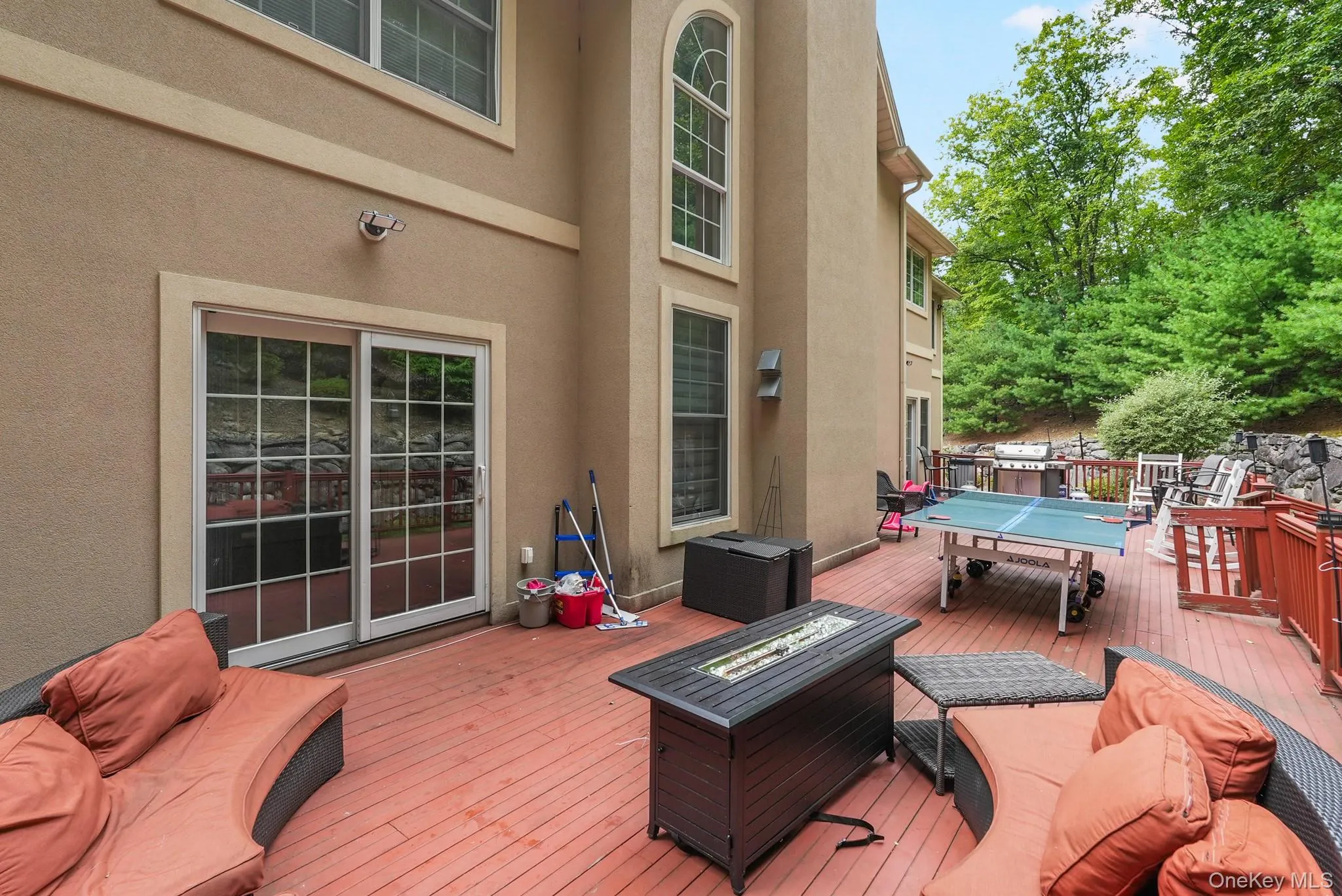 Deck featuring outdoor dining space and a fire pit Deck featuring outdoor dining space and a fire pit