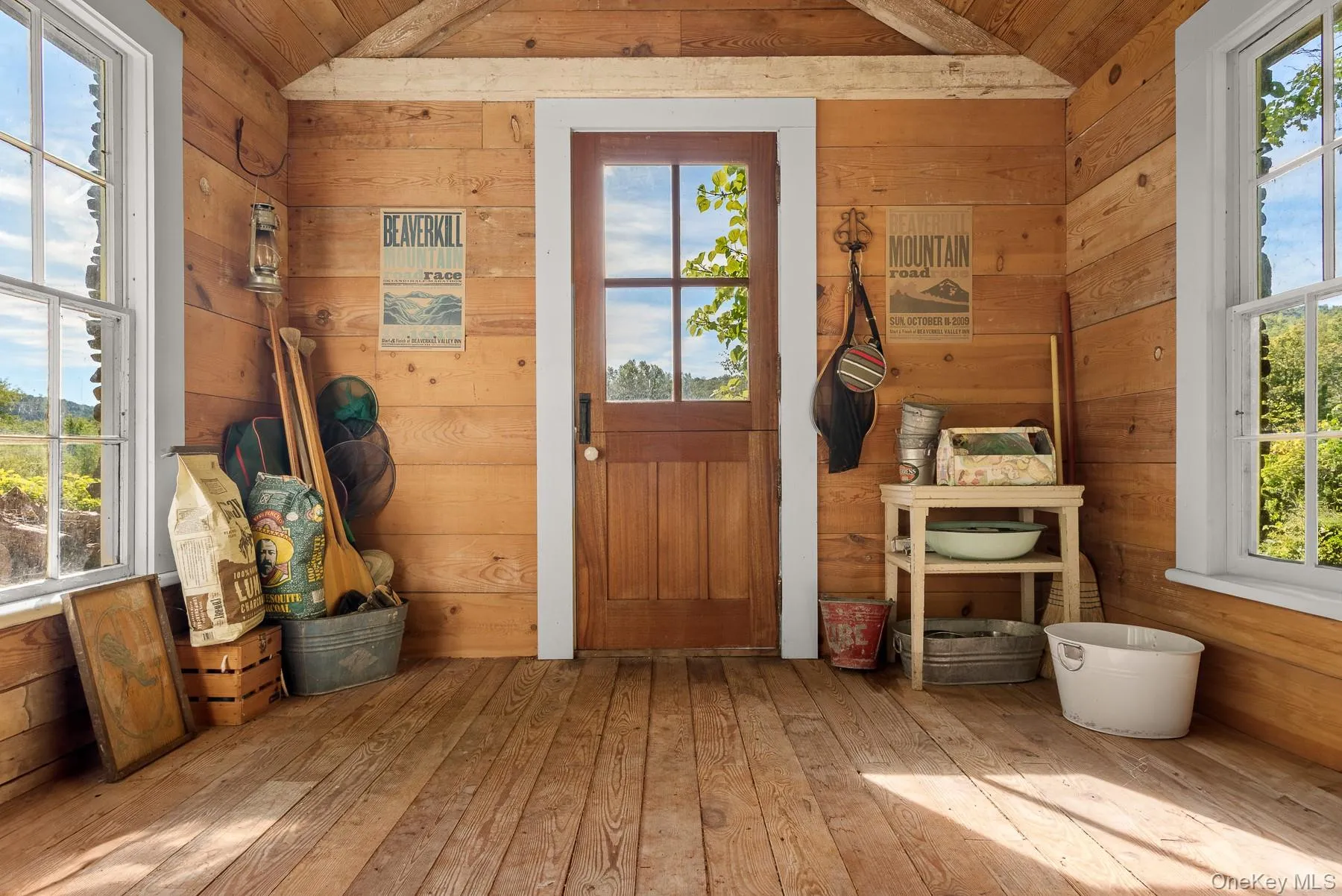 Entryway with wooden walls, healthy amount of natural light, wood-type flooring, and wood ceiling Entryway with wooden walls, healthy amount of natural light, wood-type flooring, and wood ceiling